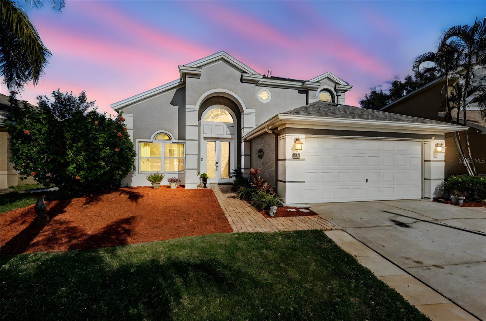 One or more photo(s) has been virtually staged. This 1,947 square foot house in the desirable Grassy Pointe subdivision features four bedrooms and two and a half bathrooms. The inviting entryway leads to a spacious layout with abundant natural light throughout. The modern appliances with quartz counters and luxury vinyl plank flooring create a cohesive and contemporary feel, while the calming color palette adds to the home's serene atmosphere. The primary first floor bedroom boasts a tray ceiling and two walk-in closets, providing ample storage space. The en-suite primary bathroom includes a soaking tub, large shower, and separate water closet. All non-stationary windows were upgraded to hurricane-rated windows in 2021, ensuring peace of mind and increased energy efficiency. The well-maintained landscaping and lush greenery create a picturesque outdoor oasis. The covered patio and freeform saltwater pool with swim-outs offer the perfect spaces for relaxation and entertainment. The low-maintenance turf between the pool deck and fencing adds to the easy-to-maintain design. Additional features include a new roof installed in 2021, a tankless gas hot water system, and an indoor laundry room. This home offers an ideal combination of comfort, style, and functionality. This home is well located near top rated schools, shopping, restaurants, the Pinellas Trail, scenic parks, golf courses and the beaches. It is minutes from downtown Tarpon Springs and the famous Sponge Docks while Tampa International Airport is just a 35 minute drive.