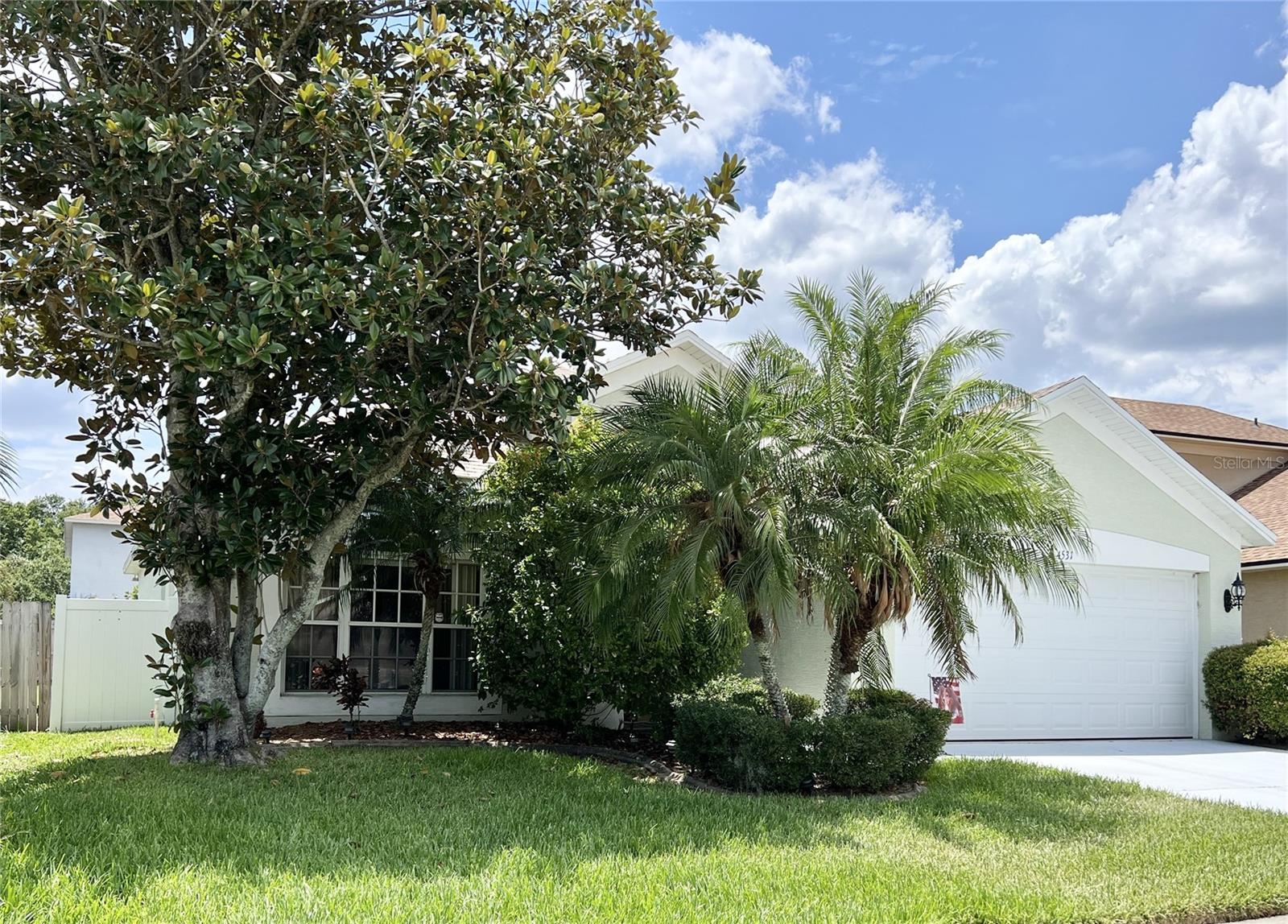 This wonderful home features an inviting front walkway that leads to a decorative glass door crowned by a beautiful arched window, filling the interior with natural light from front to back. The two versatile front rooms can serve as formal living areas, a home office, or game spaces to fit your lifestyle.The spacious kitchen offers ample cabinet and counter space, newer appliances, and a large closet pantry—perfect for all your culinary needs. A peninsular bar separates the kitchen from the dinette area, creating the ideal spot for gathering with family and friends.The cozy family room includes built-in planter shelving, perfect for displaying favorite décor pieces. The master suite is a true retreat with a large walk-in closet, while the master bath features dual sinks, a relaxing garden tub, and a separate shower.Step from the family room onto the screened back patio—an excellent place to unwind and enjoy the Florida sunshine. Community amenities include a pool, tennis court, basketball court, and playground. Conveniently located just minutes from I-75, this home provides easy access to Tampa, Wiregrass Mall, Tampa Premium Outlets, and a variety of restaurants and retail shops. Don’t miss the opportunity to make this beautiful home yours!