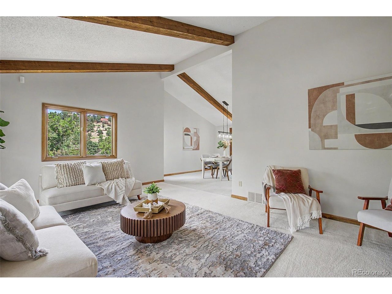 Nestled on a private, treed lot in Rockrimmon, this stunning home offers the perfect blend of privacy, functionality, and foothill living. Designed with today's lifestyle in mind, the home features exceptional work-from-home spaces including a library, sprawling office, and unique spiral stairway leads to a versatile loft that can easily serve as a second office, fitness area, or media retreat. The inviting living room showcases soaring beamed ceilings and walls of windows that fill the home with natural light. The formal dining room is beautifully appointed with a bay window. Italian porcelain flooring leads to the kitchen. The kitchen offers abundant cabinet and counter space, double-thick granite countertops, new stove top range & dishwasher and a dining nook. Ideal for entertaining, the kitchen flows seamlessly into the formal dining room and overlooks the spacious family room. Unwind in the cozy family room featuring soaring ceilings and a marble fireplace. The luxurious primary suite serves as a private sanctuary, featuring a spa-inspired bath and an adjoining sitting and dressing area designed for comfort and relaxation. Upstairs, you'll find an additional bedroom, a full bathroom, and the flexible loft space. The finished walk-out basement provides a recreation room perfect for gaming, movies, or hobbies, along with an additional bedroom and bathroom. Outdoor living is equally impressive. Enjoy peaceful mornings and tranquil evenings on the composite deck overlooking the secluded backyard, where mature pine trees and native scrub oak create a serene, park-like setting and exceptional privacy. This move-in ready home offers a 3-car garage, Lianro metal roof & hot tub. Located in one of Colorado Springs' most sought-after communities, this exceptional Rockrimmon home offers easy access to parks, hiking trails and top-rated schools. Surrounded by Colorado's natural beauty, this home provides an elegant retreat just minutes from the city's conveniences.