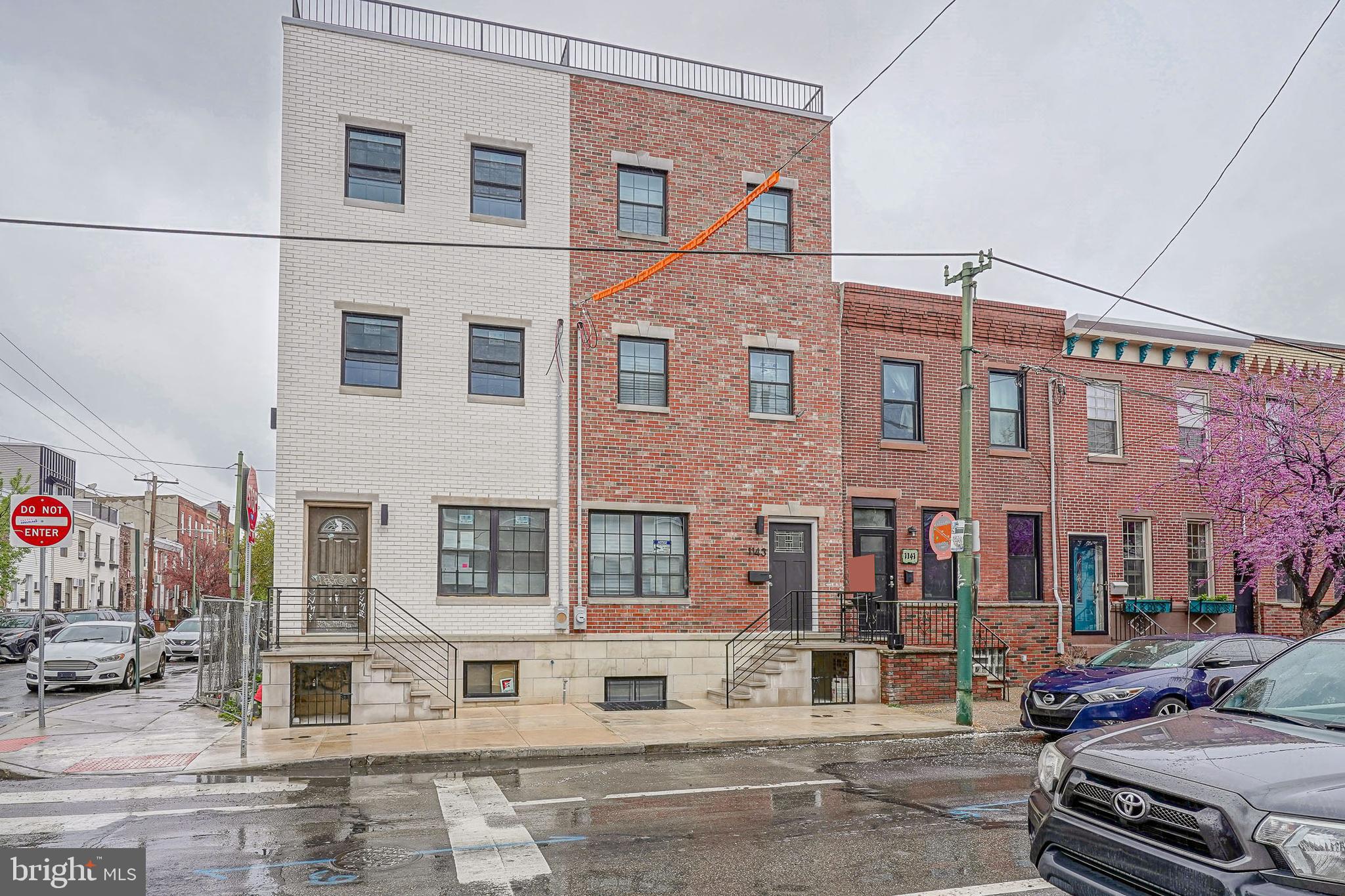 Welcome to 1143 Tasker St – A Truly Exceptional New Construction Home in Passyunk Square. This stunning 3-story residence offers 4 spacious bedrooms, 4.5 luxurious bathrooms, and over 3,000 sqft of thoughtfully designed living space. Featuring 9-foot ceilings on every floor, this home is filled with natural light and elevated by custom, high-end finishes throughout. Step inside to find luxury vinyl floors flowing through every level, anchored by a striking custom oak and wrought iron staircase that connects all three stories. The heart of the home is the chef’s kitchen, showcasing custom oak cabinetry, a waterfall quartz island with pendant lighting, a sleek quartz backsplash, and premium Café appliances, including a wine fridge—perfect for entertaining. The second floor offers two generously sized bedrooms, each with ample closet space and private en-suite bathrooms. On the third floor, you’ll find two additional large bedrooms, including a luxurious primary suite featuring a spacious walk-in closet and a spa-like bathroom complete with a double vanity and quartz countertops. A stylish hallway bathroom serves the additional bedroom on this level. Enjoy rooftop relaxation on the fiberglass roof deck with breathtaking views of the Philadelphia skyline. The fully finished basement provides additional versatile living space—ideal for a home office, gym, or media room. Located just steps from the vibrant Passyunk Avenue strip, you’re surrounded by Philly’s top restaurants, bars, boutique shops, and all the energy of this beloved neighborhood. This home truly has it all—style, space, luxury, and location! Schedule your tour today!Lender paid 1-0 Buy-Down with financing through Movement Mortgage, reach out for further information!