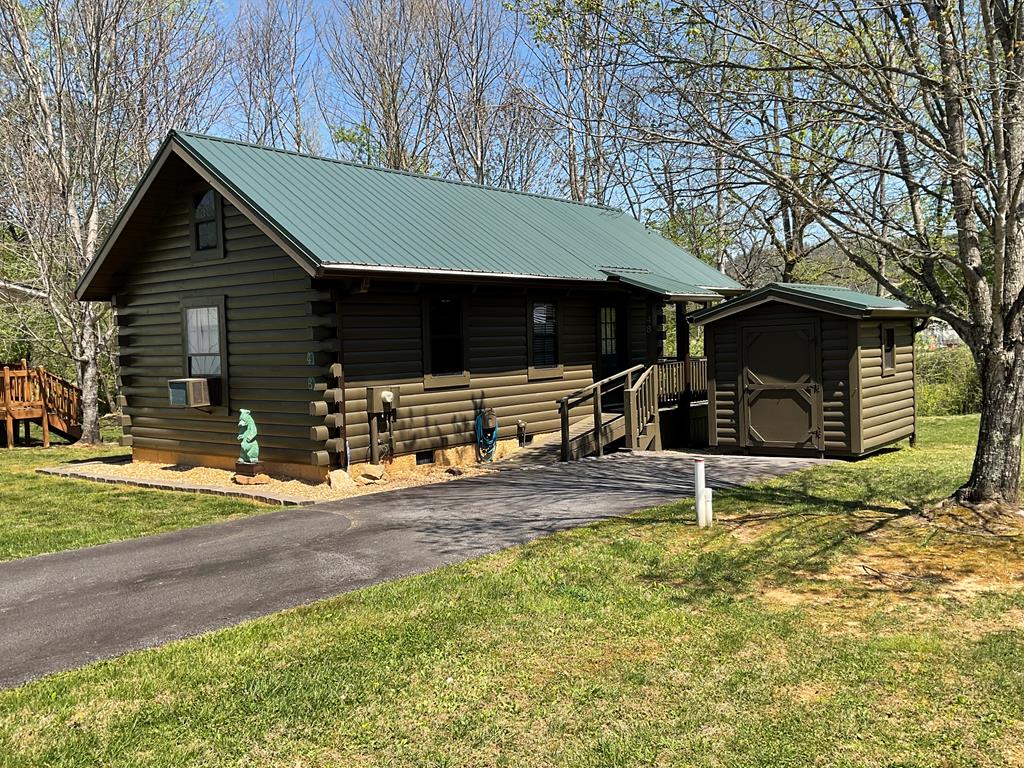 Charming Log Cabin Tiny Home on Junaluska Creek – Fully Furnished & Move-In Ready! Nestled in the picturesque mountain valley of Andrews, NC, this adorable one-bedroom one bath log cabin tiny home is the perfect retreat — whether you're looking for a full-time residence, vacation getaway, or investment property. Meticulously maintained and bursting with character, this gem is ready for its next chapter. Step outside onto the back deck and listen to the soothing sounds of the Rushing  Creek flowing right behind you — your own private slice of nature. Inside, the home has been tastefully decorated with warm, inviting finishes, making this a truly turnkey experience. The updated kitchen and bathroom offer modern comforts while maintaining the cozy cabin charm you'd expect. An outdoor storage shed and paved driveway add everyday convenience, while city water and city sewer mean worry-free living with no well or septic to maintain. Located just minutes from everything Andrews has to offer — great local restaurants, craft breweries, and a vibrant small-town atmosphere — you'll also enjoy easy access to world-class outdoor adventures including whitewater rafting, fishing, and mountain biking. The Harrah's Cherokee Valley River Casino in nearby Murphy is just a short drive away for an evening of entertainment. The town of Andrews is surrounded by stunning mountain views on all sides, this rare find checks every box. Properties like this don't last long — schedule your showing today