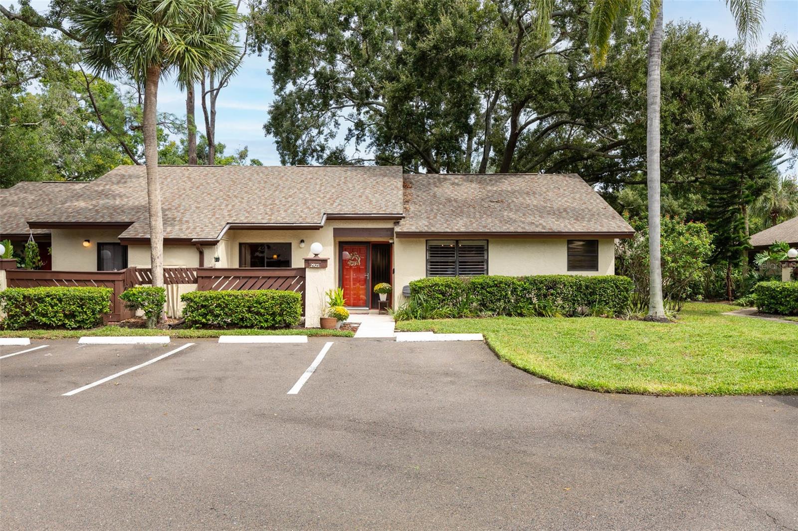 WELCOME TO STRATHMORE GATE EAST, where mature trees, winding streets and a relaxed, low-maintenance lifestyle create a surprisingly peaceful setting in the heart of Palm Harbor!!! This spacious END-UNIT VILLA offers 1,298 square feet with 2 bedrooms, 2 baths and a thoughtfully modified floor plan that makes the main living areas feel especially open and inviting…… A room that is often configured as a third bedroom in this floor plan has been opened to create a true formal dining room, providing wonderful entertaining space while allowing the adjoining living area to feel even more expansive….. Step inside through a welcoming foyer and you'll immediately appreciate the easy flow of the main living spaces….. The kitchen features abundant cabinetry and counter space, stainless steel appliances, a breakfast bar and an open connection to the generously sized living room…… Luxury vinyl flooring extends through much of the living and bedroom areas, while recessed lighting and neutral finishes add to the bright, comfortable feel….. The spacious primary bedroom includes generous closet space and a private ensuite bath, while the second bedroom offers space for guests, an office or whatever best suits your needs…..Outdoor spaces include both a private front patio with convenient access from the kitchen and a covered, screened rear lanai overlooking mature trees and community green space……. An exterior storage closet provides additional storage, and the washer and dryer are conveniently located inside the villa…... Major components offer additional peace of mind with roof shingles approximately 2 years old and HVAC and water heater updated in 2019….. Strathmore Gate East offers a community pool and tennis court surrounded by established landscaping and beautiful tree cover, with the monthly association fee providing for a number of exterior and community services like water/sewer/trash……    Even better, this villa is located in FLOOD ZONE X, where lenders do not typically require flood insurance….  The location makes everyday life exceptionally convenient, with quick access to Tampa Road, East Lake Road/McMullen Booth Road and US 19, putting shopping, restaurants, medical facilities and everyday necessities within easy reach…... Publix, Target and the shops and restaurants of the Boot Ranch area are nearby, while beautiful John Chesnut Sr. Park on Lake Tarpon offers miles of opportunities to enjoy the outdoors….. Head west for downtown Palm Harbor, the Pinellas Trail and the Gulf beaches, or easily reach Dunedin, Tarpon Springs and surrounding communities…... Comfortable, spacious and wonderfully convenient, this END-UNIT villa offers an easy Florida lifestyle in one of Palm Harbor's established villa communities.