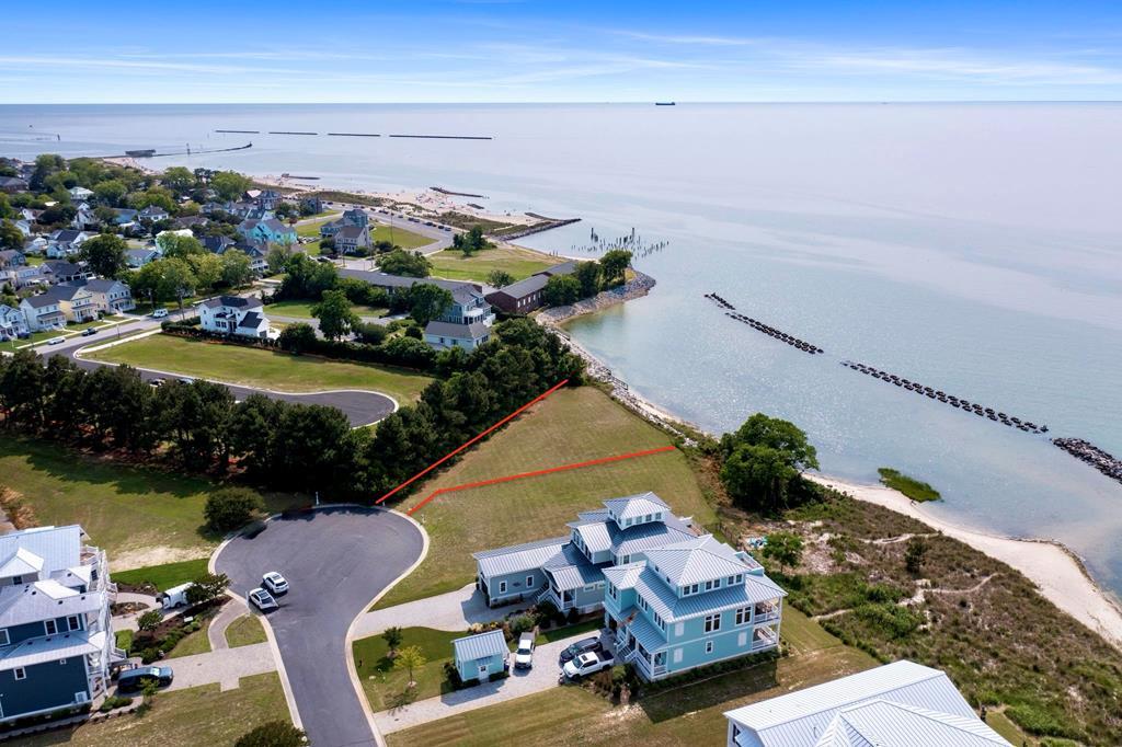 WATERFRONT! Located in the The Colony neighborhood within Bay Creek, this exceptional waterfront half-acre homesite offers a rare opportunity to build along the shores of the Chesapeake Bay. Perfectly positioned to capture sweeping water views and unforgettable sunsets, this property showcases the coastal beauty and tranquility that make Bay Creek one of Virginia's most sought-after communities. With no required timeframe to build, you can secure your homesite now and design your dream coastal retreat when the time is right. Whether envisioning a full-time residence or luxury getaway, this homesite offers the perfect setting for custom waterfront living. Residents enjoy access to private beaches, resort-style pools, scenic nature trails, preserved green spaces, and nearby marinas, all just minutes from the charm, shops, and dining of historic Cape Charles. Waterfront homesites with unobstructed Chesapeake Bay views are becoming increasingly rare—especially within The Colony. Now is the time to invest in waterfront living and secure one of the Eastern Shore's premier homesites. Inquire today!