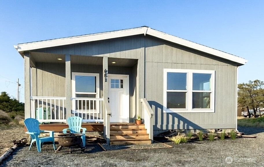 Welcome home to this charming coastal retreat near the Beach and the North Jetty. Take a stroll on the nearby beach trail, or stand in awe at the king tides at the Jetty.  This 3 bedroom, 1.75 bath, approx. 1,320 sq.ft. new construction doublewide manufactured home offers a covered front deck and a large yard set up for easy maintenance. Enjoy the open concept layout designed for easy entertainment. The stylish kitchen boasts stainless steel appliances, full height upper cabinets, and a large island with eating bar. The primary suite bathroom has convenient dual vanities and a walk-in shower.  There's lots of room to store your beach wear in the primary suite's walk-in closet.  And, with 2 extra bedrooms, there is plenty of room to invite friends. Bonus: Stay warm with the Heat Pump. You don't want to miss this opportunity to own at the Beach at such an affordable price!