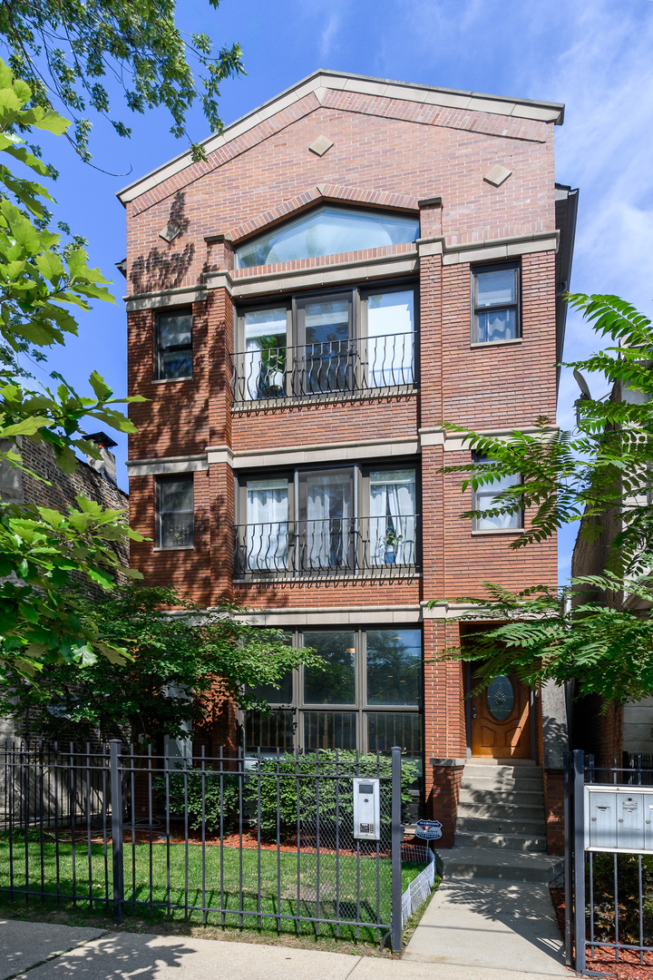 Experience over 2,300 square feet of thoughtfully designed living space in this spacious 3-bedroom, 2.5-bath duplex-down located in Chicago's sought-after Avondale neighborhood. With high ceilings, abundant natural light, beautifully updated bathrooms, hardwood floors, and a lofted layout that opens to the lower level, this home offers the feel of a single-family residence. The main level welcomes you with a dedicated dining area, a cozy sitting area anchored by a wood-burning fireplace, and an open-concept kitchen with new Frigidaire appliances and granite countertops. Down the hall, you'll find a convenient half bath on this level, as well as your spacious primary suite with a private balcony and an ensuite bath. The ensuite bath features so much space, including an oversized soaking tub, separate shower, and dual vanities. You will love the walk in closet in the primary! The lower level expands the living space with a second living room area that is perfect for entertaining and relaxing, a wood-burning fireplace, oversized windows, new carpet (2024), two additional bedrooms, a full bath, laundry area, and tons of closet storage. An exterior tandem parking space that accommodates 2 cars and a dedicated storage unit are included in the price! This home also features numerous recent upgrades: fresh paint throughout (2025), new roof and ejector pump with warranty (2024), updated kitchen and painted exterior stairs (2023), fireplace flue cleaned (2022), three bathrooms fully updated, deck rebuilt, and windows resealed (2021), new carpet in the primary bedroom and brick flashing/sealing (2019). Located just steps from the CTA, expressway, local restaurants, coffee shops, and Brands Park, this home places you at the center of Avondale's vibrant community. Don't miss your opportunity to own this exceptional property!
