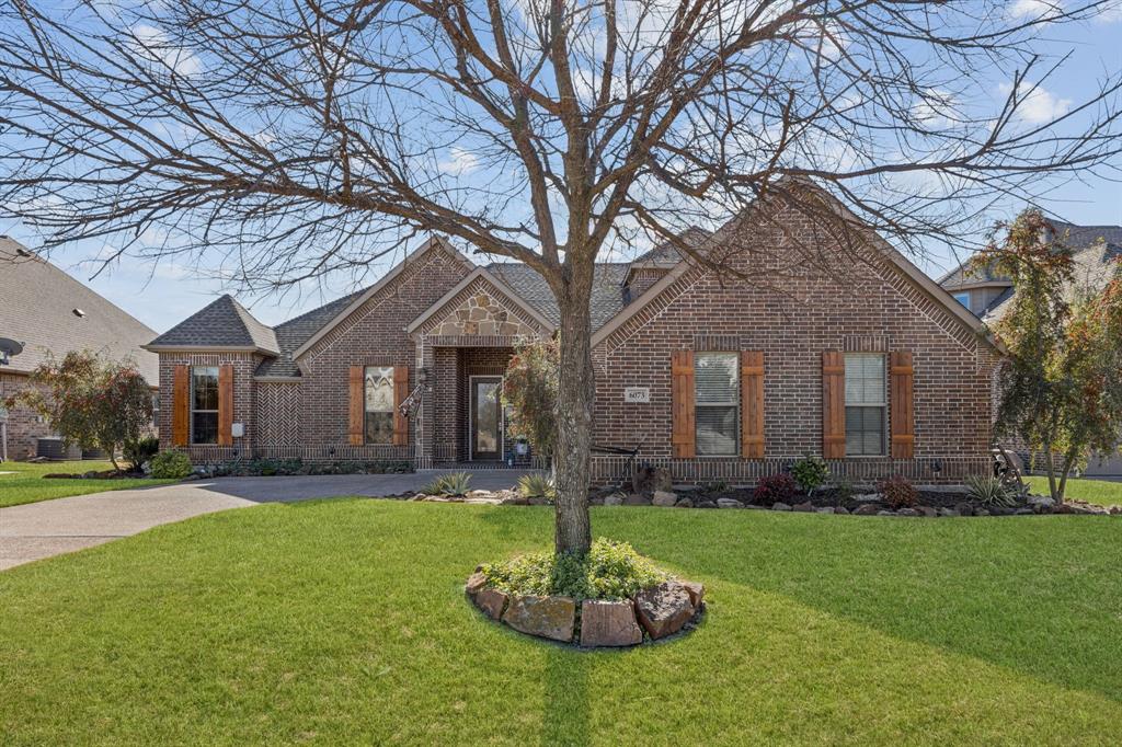 Located in the 24-7 gated and guarded community The Resort, the only golf course and lake community on Eagle Mtn. Lake! This beautifully updated home offers an unmatched blend of luxury, privacy, and lifestyle. Perfectly positioned on the golf course, this home delivers stunning views and resort style living at its finest. The thoughtfully designed floor plan features four bedrooms on the main level, while the upstairs retreat offers endless possibilities, ideal as a fifth bedroom, game room, media room, or private in-law suite, complete with a full bathroom and closet for ultimate privacy.Designed for entertaining, the open concept living, kitchen, and dining areas create a seamless flow. The chef’s kitchen showcases crisp white cabinetry, quartz countertops, a gas range, abundant storage, and beautifully updated lighting. Gorgeous hardwood floors extend into the expansive primary suite, which overlooks the golf course and features a stunning, updated spa like bath and private patio access—the perfect place to unwind.Three additional bedrooms on the first floor are thoughtfully situated on the opposite wing of the home and share a full bathroom, offering comfort and functionality for family or guests. The oversized driveway is perfect for additional parking and the garage has additional room for a fridge, storage, etc. Residents enjoy endless amenities, including a 18-hole golf course, clubhouse with restaurant and bar, two pools, fitness center, pickleball and basketball courts, community boat slips and boat ramp, and a private beach area with pergolas.Conveniently located just 30 minutes from Downtown Fort Worth and DFW Airport, this home offers the perfect balance of tranquility and accessibility.Please ask for the full list of upgrades, there are too many to list!