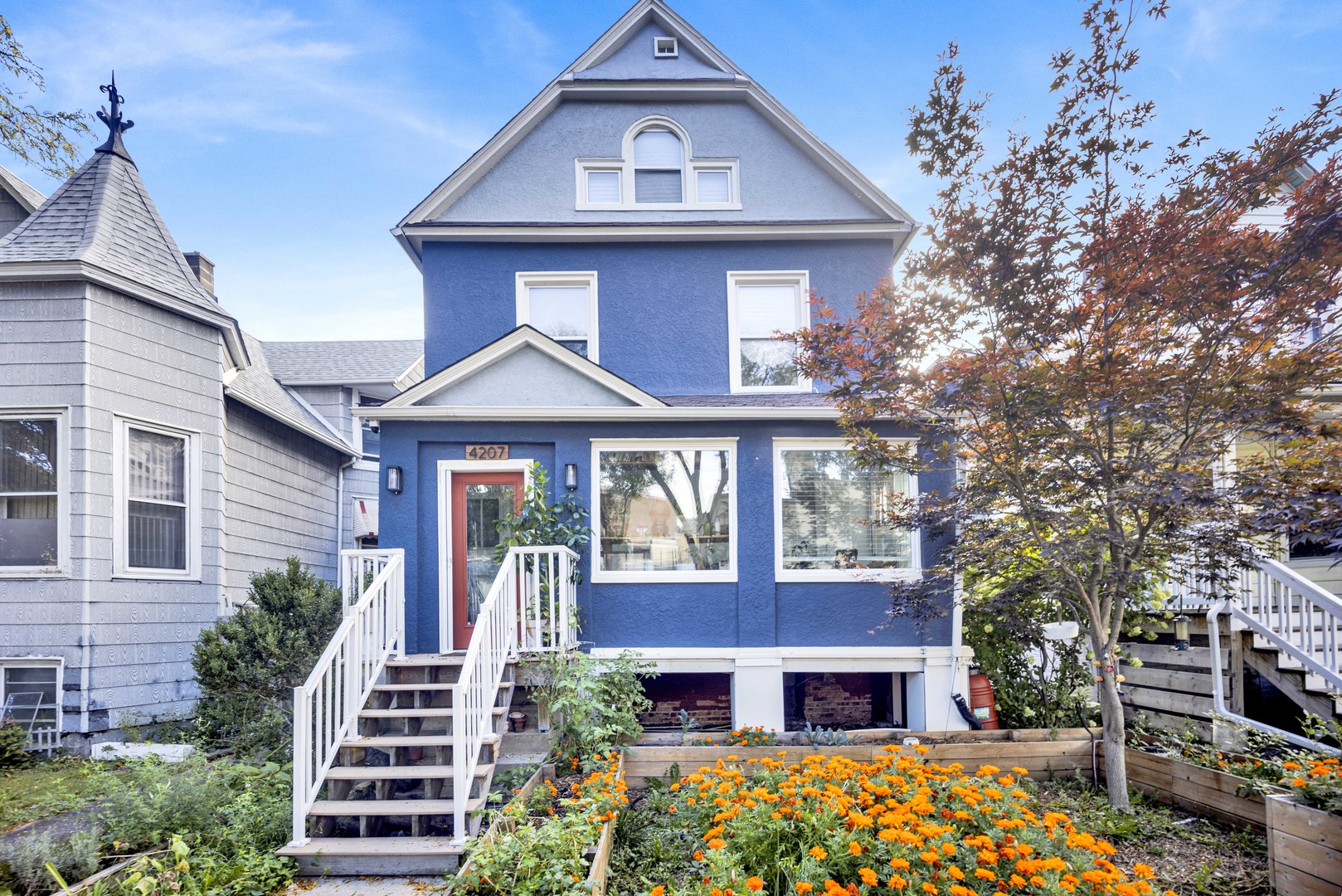 Beautiful four-level home on an extra-wide lot in Chicago Irving Park's West Walker neighborhood. This 5 bedroom home with 2 full baths and 2 half baths offers generous space inside and out with a rare blend of historic charm and modern updates. Set on a quiet tree-lined street, this home welcomes you with original stained glass, intricate oak woodwork, and vintage character that has been lovingly maintained. The first floor has been opened up for a spacious and connected kitchen and living area-perfect for holidays, dinner parties, or cozy nights in. The kitchen is designed to be both functional and social, with a large central island, window-side counters, and ample space for gathering.  Just off the living area, a former porch has been enclosed into a bright sunroom filled with natural light. Currently used as a home office, it could easily serve as a reading nook, studio, or morning coffee retreat. The fully finished basement is thoughtfully designed, with separate mechanical/storage areas and a convenient half bath. Upstairs, the second floor continues the home's historic narrative with original moldings and doors. The standout is a spa-inspired bath featuring a wet room, standalone soaking tub, double sinks, and full-size washer/dryer. Three bedrooms on this level offer flexibility for family, guests, or a second office. The third floor adds even more space, with two oversized bedrooms and a full bath featuring a skylight in the shower and sweeping neighborhood views. Dedicated heating/cooling ensures comfort year-round. The outdoor space is just as impressive. The tallest home on the block, it offers two private balconies. The backyard has been transformed into a low-maintenance urban oasis with a spacious concrete pad- ideal for entertaining, basketball games, or fireside evenings under string lights. Hand-built cedar garden boxes along the front and side provide space for herbs, vegetables, or flowers. Parking is a breeze with a two-car garage plus an additional side space. From top to bottom, this home is designed for connection, comfort, and joy. 4207 North Avers Avenue is more than a place to live-it's a place to belong. Come see what makes it so special.