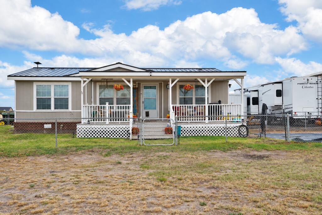 Seller offering $15,000 closing credit!! Greenwood ISD! Situated on 2 acres, this well-kept 3 bedroom, 2 bath home offers a spacious living area, beautiful wood-look flooring, and a generously sized kitchen with abundant cabinetry and counter space. Outside this property shines! Large metal workshop with overhead door, expansive covered parking, additional storage building, and plenty of gravel parking for trailers, RVs, and equipment. Fenced yard, mature shade tree, and inviting covered front porch complete this country property with room to spread out! Water is not a problem here!