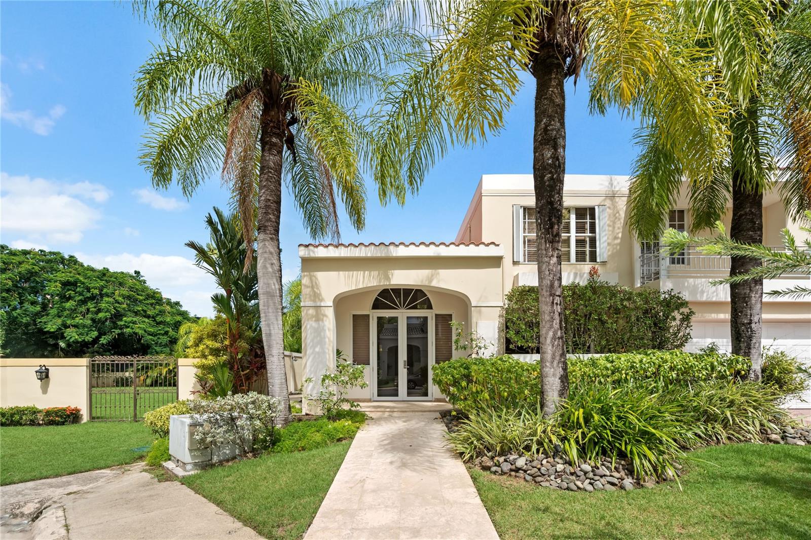 Discover beautifully balanced living in this five-bedroom, four-and-a-half-bath residence located in the sought-after gated community of Palma Real, Guaynabo. Offering just over 500 m² of thoughtfully designed space, the home combines comfort, style, and abundant natural light throughout.The property is in excellent condition, featuring warm, inviting interiors that flow seamlessly from room to room. The primary suite offers his-and-her walk-in closets and a spa-inspired bathroom highlighted by a striking glass-ceiling shower. A junior suite on the second level includes a private terrace, creating a quiet and private retreat.Outdoor living is enhanced by a marble-floor open deck, a covered terrace, heated pool and serene garden views, with a park located directly behind the property providing added privacy and a lush natural backdrop rarely found within a gated community.Residents of Palma Real enjoy controlled access, 24-hour security patrol, and a prime Guaynabo location close to top schools, dining, shopping, and everyday conveniences. Community amenities include a gym, clubhouse, swimming pool with gazebo, basketball court, beach tennis and pickleball courts, a full tennis court, and a playground, all set within beautifully landscaped grounds.Additional features include a full power generator, double enclosed garage, and ample storage throughout. An exceptional opportunity to own a spacious, well-appointed home in one of Guaynabo’s premier residential communities.