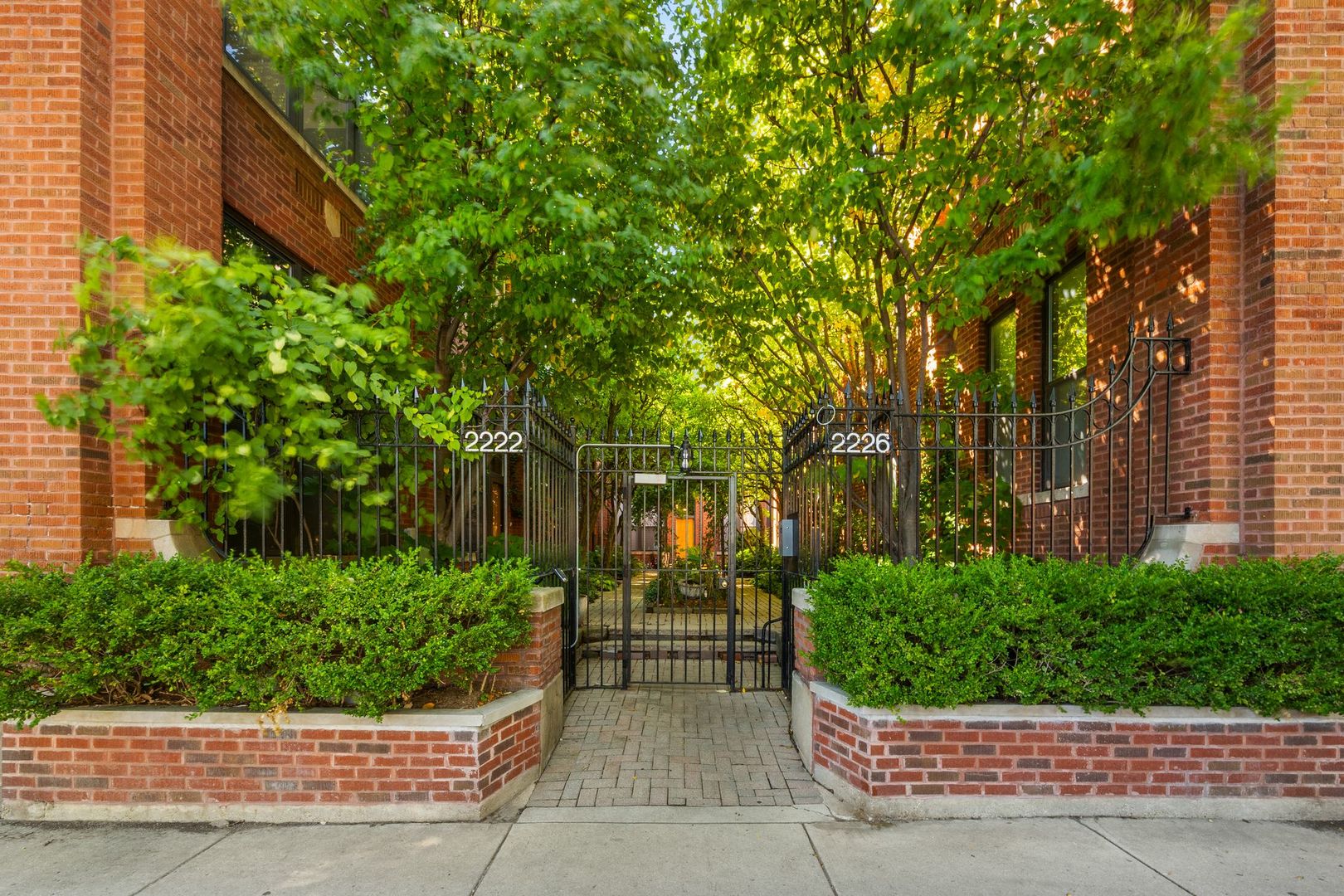 Tucked away in a quiet, gated courtyard, this 3 bed, 3.5 bath Lincoln Park triplex with brick and timber accents throughout delivers the space and character of a single-family home with the ease of condo living, all in the sought-after Oscar Mayer school district. Soaring ceilings, exposed brick, and timber beams create a dramatic backdrop in the main living area, where oversized windows flood the space with light. The open kitchen features chic new tile flooring, stainless steel appliances, and plenty of room to cook and gather, overlooking both the dining and living rooms anchored by a cozy fireplace with wood mantel and hearth. Two spacious bedrooms on the lower level include a serene primary suite with custom walk-in closet and spa-like bath with a double vanity and oversized shower, while the top level offers a flexible third bedroom or family room with its own full bath and rooftop deck access. Throughout, thoughtful updates like wool runner staircase carpeting and electronic window shades add comfort and style. With garage parking, a private rooftop retreat, and a location just steps from Trebes Park, the Armitage and Fullerton El stops, and some of the city's best dining and boutiques, this home brings together warmth, character, and convenience in the heart of Lincoln Park.