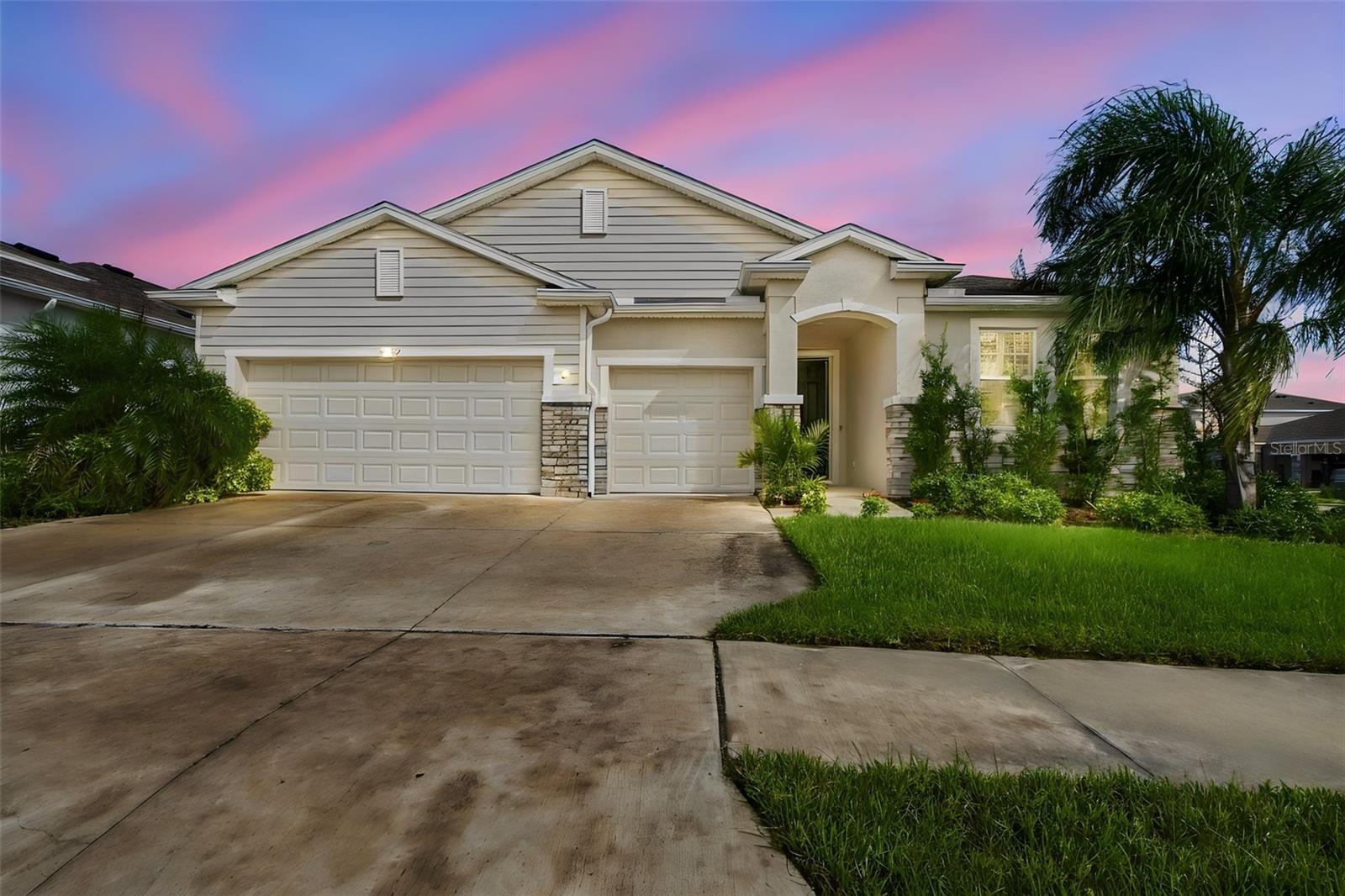 Virtually Staged. Welcome to 32337 Conchshell Circle, a beautifully maintained DR Horton Camden model in the highly sought-after Epperson community of Wesley Chapel. Built just three years ago and showing like new, this exceptional one-story home offers something increasingly difficult to find: true multigenerational living with a private, fully equipped in-law suite under the same roof.With approximately 2,800 square feet of thoughtfully designed living space, the home features 4 bedrooms, 3 full bathrooms and 1 half bath, and a 3-car garage, along with 9.5-foot ceilings that enhance the already spacious, open feel of the home. The heart of the home is the expansive main living area, where the chef’s kitchen—with 42-inch cabinetry—flows seamlessly into the great room, dining area, and covered lanai.The standout feature is the private multigenerational suite, designed to provide genuine independence and privacy for parents, adult children, extended family, or long-term guests. The suite includes its own kitchen, bedroom, walk in closet, full ensuite bathroom, and separate living space, creating the feel and functionality of a private apartment while remaining connected to the main home. It’s an ideal solution for families who want to live together without sacrificing personal space.The primary suite is privately positioned at the rear of the home and features a spacious ensuite with dual vanities, separate shower and soaking tub, and a generous walk-in closet. Additional bedrooms provide flexible space for family, guests, or a home office.The current owners have thoughtfully enhanced the home with approximately $5,000 in high-quality custom window shutters throughout all bedrooms, along with an in-home water softener and filtration system and an installed ADT security system. Combined with the home's young age and meticulous condition, this is a property where you can move in and simply enjoy.And then there is Epperson—one of Wesley Chapel's most distinctive master-planned communities and home to the famous 7.5-acre Crystal Lagoon. Residents enjoy lagoon access with opportunities for swimming, kayaking, paddleboarding, water slides, a swim-up bar, private cabanas, and more. The community also offers a 5-acre dog park, playground, Zen garden, community Wi-Fi, and additional recreational amenities.Beyond the community, Epperson puts you close to the best of Wesley Chapel, with convenient access to top-rated schools, shopping, dining, healthcare, major highways, and Interstate 75. Publix, Target, Wiregrass, The Shops at Wiregrass, Tampa Premium Outlets, and an ever-growing selection of restaurants and entertainment are all within easy reach.A beautiful nearly-new home. A true multigenerational floor plan. Exceptional community amenities. And a location that keeps you connected to everything Wesley Chapel has to offer. This is more than a place to live—it is a home designed to accommodate the way families live today.Schedule your private showing and experience 32337 Conchshell Circle for yourself.