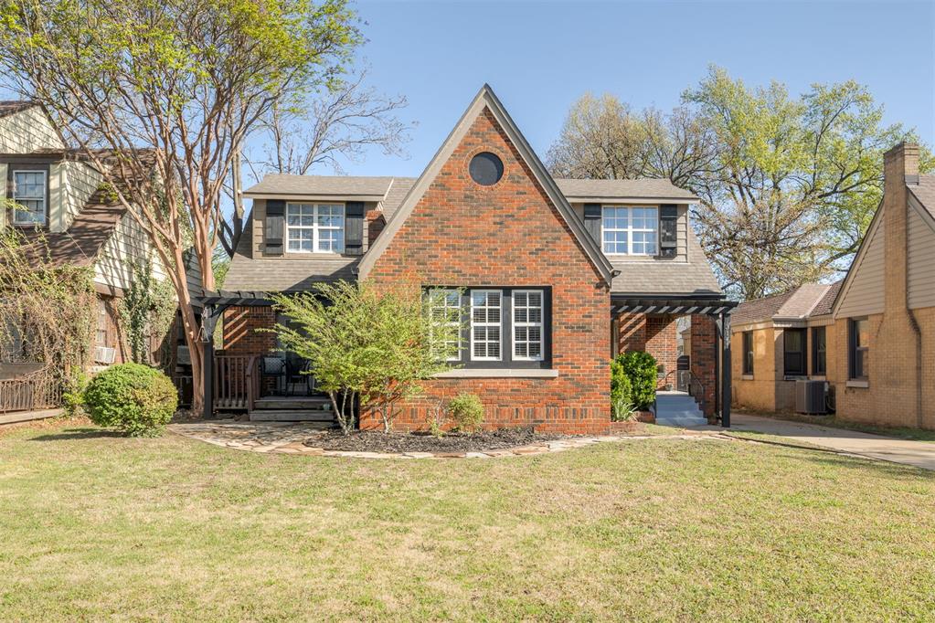 This Charming 1939 Tudor in a prime neighborhood near Denniston Park is truly one of a kind. This beautifully updated 3 bed, 2 bath home blends original character with modern touches. Features include original hardwood floors, solid wood front door with speakeasy, and a spacious living room with vaulted ceilings, cedar beams, chandelier, and gas fireplace. The dining room offers custom cabinetry with accent lighting and French doors leading to a wood deck. Kitchen includes custom cabinets, gas range, built-in microwave, stainless steel appliances, granite countertops, pantry, breakfast bar, and wine cooler. Architectural details throughout—arched openings, niches, and bullnose corners. One bedroom and full bath downstairs; upstairs features two large bedrooms (one with cedar-lined walk-in closet), office nook with built-ins, and second full bath. Enjoy the inviting front porch and private backyard with a brand new fence. Additional features include basement storage, sprinkler system, security system, new outdoor lighting, and recent roof, guttering, and exterior paint.