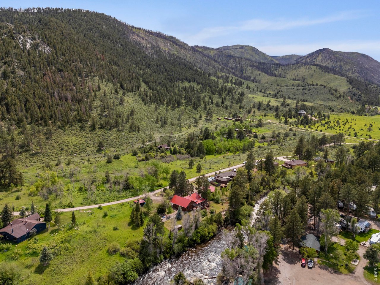 Escape the noise and rediscover the rhythm of nature at 428 Rustic Road, an extraordinary riverside retreat nestled in the heart of the Upper Poudre Canyon. Tucked away on a quiet private road within the Roosevelt National Forest, this property offers a level of serenity that is increasingly rare. Inside, the main residence breathes with character. Artisanal finishes, including live-edge wood moldings and natural trim, create a seamless connection to the outdoors. The heart of the home is a cozy living area anchored by a wood-burning stove perfect for cool Colorado evenings. A spacious four-seasons room adjoins the well-appointed kitchen and dining area, offering a sun-drenched space to watch local wildlife roam the lot and your slice of the river. Enjoy family game nights in this special space or cozy up with your new book. The primary suite serves as a private haven with your own ensuite bathroom boasting dual vanities, large walk-in shower and oversized closet. The main house includes two other bedrooms giving space to spread out and a brand new water heater installed in June 2026. The magic extends across the grounds to a charming, detached studio. Separated from the main house by the sounds of the private mineral brook, this room features its own full bath and kitchenette. The lifestyle here is defined by your immediate access to the wild. You can experience true stillness on the back deck, where a hot tub awaits under some of the clearest stargazing skies in Northern Colorado, or enjoy the front porch overlooking a landscape with seasonal wildflowers and towering pines. All the while you are just steps away from world-class fishing on the Cache La Poudre River and the modern amenities Glen Echo has to offer. You also remain conveniently connected, located only an hour from Fort Collins. Embrace the stillness of the canyon and secure your legacy in this rare, high-country retreat.