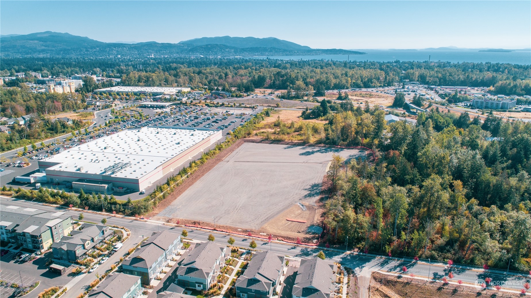 5.71 useable acres of Planned Industrial zoned property next to Costco in Bellingham ready for your building plans.  This property has been cleared, graded, compacted, and covered with crushed rock. Another huge plus for the property is that it has been connected to the City of Bellingham Regional Stormwater Facility which allows for maximum use of the property. Heavy power, natural gas, city water and sewer are in the street fronting the property. The completed entitlements to build on this property cost well over 1.5 million dollars and took several years of effort allowing for the buyer to expedite their construction and use of the property. Seller also owns adjacent planned commercial property that fronts Pacific Hwy.