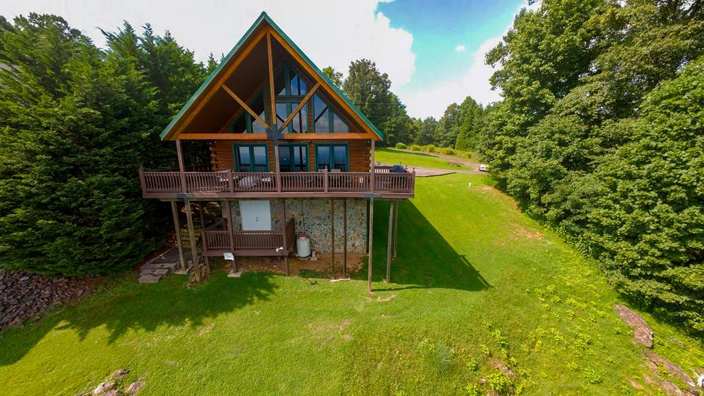Pilot's Perch Too – Rustic Log Cabin with 60+ Mile Views just off the Blue Ridge Parkway in Fancy Gap VA.  Welcome to Pilot's Perch Too, a solidly booked short-term rental and guest favorite! Nestled just off the parkway, this 3-bedroom, 2-bath rustic log cabin offers breathtaking 60+ mile long-range views, including the iconic Pilot Mountain, the rolling Piedmont of North Carolina, and unforgettable sunsets over the Blue Ridge Mountains.  Designed for both relaxation and entertainment, the cabin features a fire pit and an outdoor grill connected to a propane tank for instant enjoyment. Inside, a gorgeous open window maximizes the views, filling the home with natural light and panoramic scenery.  Ownership is simple and stress-free with no HOA dues—just a low-cost road maintenance fee. Combined with its rustic charm, cozy atmosphere, and unmatched outdoor amenities, Pilot's Perch Too is perfect as a private retreat or proven income-producing rental. Guests consistently rave about the views, sunsets, and welcoming mountain setting.  Close to wineries, shopping and restaurants.  Mabry Mill, Blue Ridge Music Center, Chateau Morrisette and Villa Appalachia wineries just minutes away.  20 minutes to Mt Airy NC, just 10 minutes from Interstate I 77! This is a Must see in person, its gorgeous inside and out. Call today to schedule your showing!!