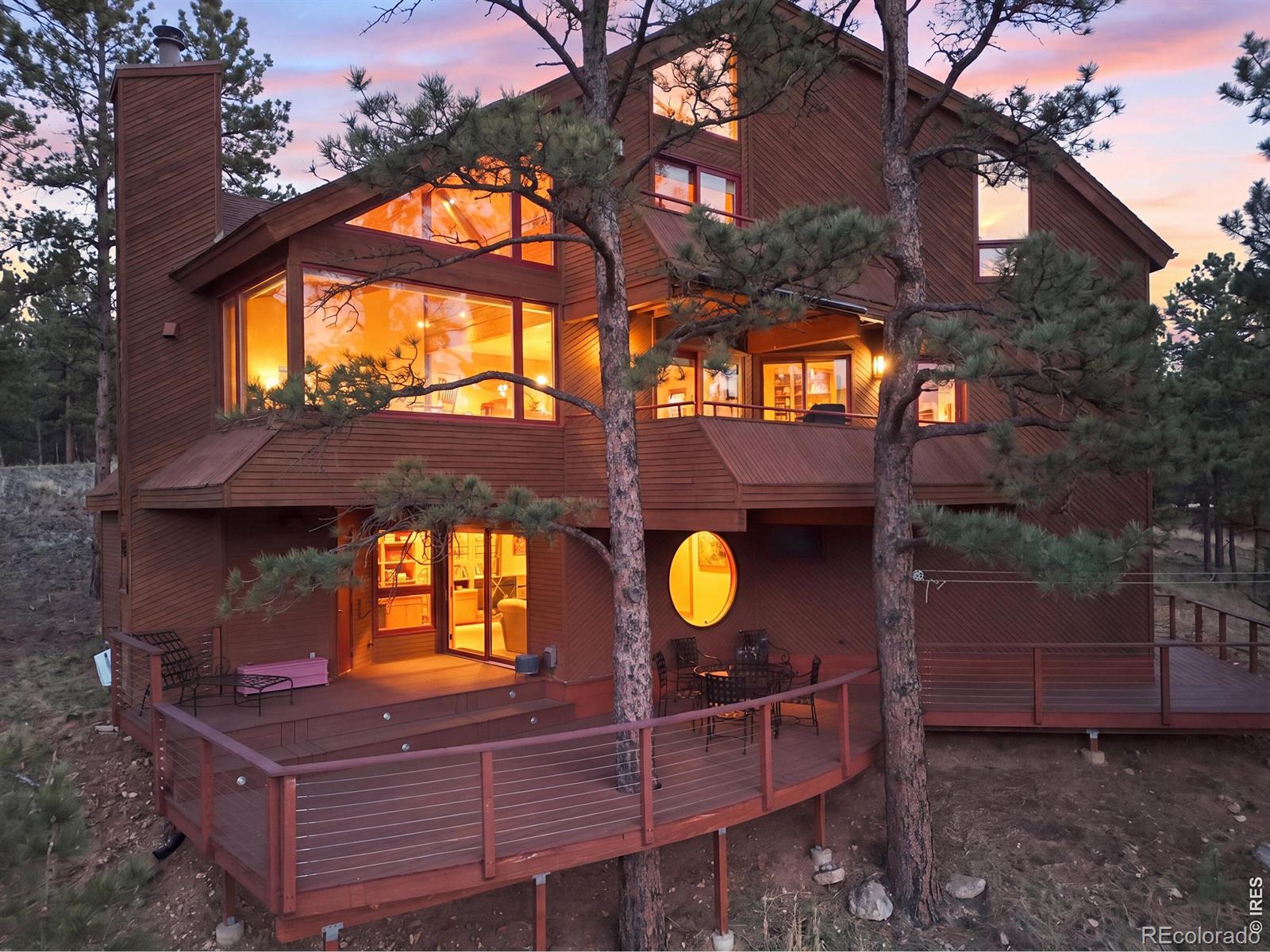 This exceptional residence, perched in the serene beauty of the Boulder foothills, offers a rare balance of tranquility and proximity-just eight minutes from the vibrant heart of downtown. Here, quiet stillness and sweeping grandeur coexist, with astonishing 270-degree views stretching across the Continental Divide and the iconic silhouette of Bald Mountain.The home's interior boasts a thoughtfully renovated kitchen that pairs understated elegance with top-tier performance. Honed granite countertops, a Sub-Zero refrigerator, and a Wolf range create a culinary space that is as functional as it is striking. A refined, mid-century-inspired primary bedroom evokes timeless sophistication, while the the walkout lower level extends the home's versatility, opening seamlessly to the surrounding landscape and inviting indoor-outdoor living at its finest. It would suit perfectly for a VRBO rental with separate entry to help support a mortgage, or think about the arrival of the Sundance Film Festival this coming January. This is more than a home-it is a private retreat defined by light, space, and the quiet luxury of nature at your doorstep.