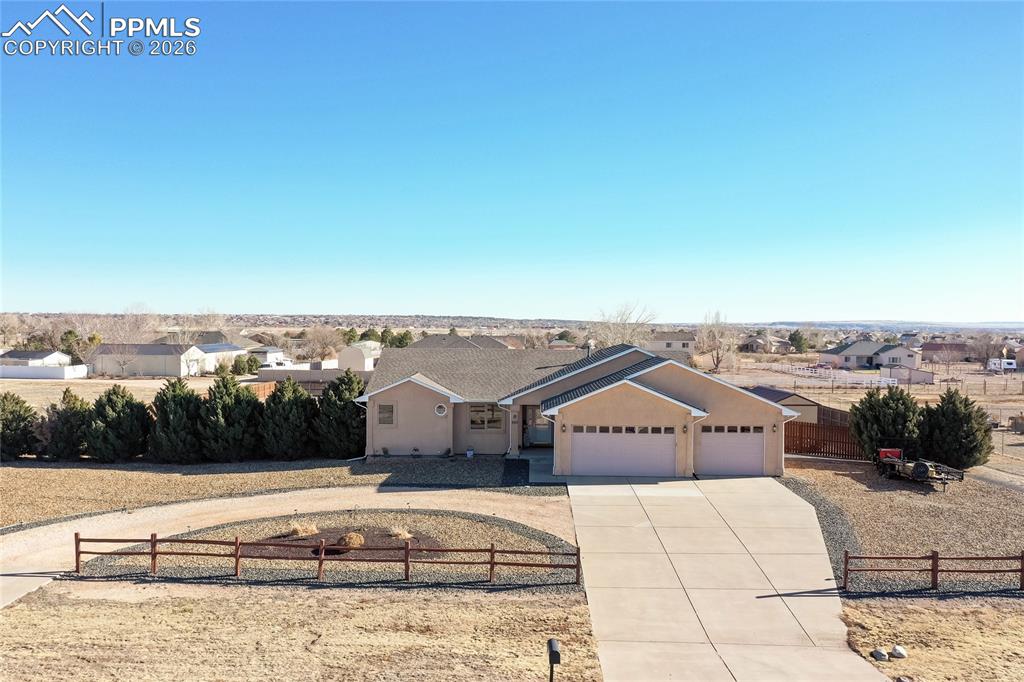 Pre-inspected and move-in ready! Enjoy the Colorado sunshine, mountain views, and open space in this beautiful Pueblo West home! From the spacious circular driveway, to the welcoming open-concept layout, this home has it all! The living areas are spacious, with plenty of room for entertaining. The kitchen features warm granite countertops, hickory cabinets, and stainless steel appliances, with an eat-in area. There are three bedrooms upstairs, unusual for a ranch plan, as well as an extra room, perfect for an office space or a formal dining room. The basement is fully equipped with two bedrooms, a bathroom, a large living area, and generous storage with an egress window, convertible to a sixth bedroom! Ready to spend time outdoors? The private, fenced backyard has both a lawn and sand volleyball area, and space for a fire pit and RV parking. Now for the practical bit: the septic was replaced in 2022, and was serviced and inspected in December 2025. The tankless on-demand water heater was installed in 2025, radon mitigation is present, and the roof is only four years old. Minutes from shopping and restaurants along Highway 50, 20 minutes to CSU Pueblo, and approximately 45 minutes to Fort Carson. Schedule your private showing, and check out this lovely, turnkey home!