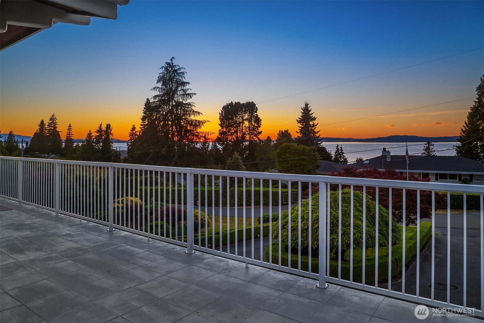 Perched above Edmonds’ coveted Talbot Park, this over 4,400 sq ft home offers sweeping West-facing views of Puget Sound, Olympic Mountains, and Whidbey Island from a private 32,200+ sq ft lot with mature landscaping. The expansive great room is designed to embrace the views, with walls of windows that flood the space with natural light and connect seamlessly to the wraparound deck—an ideal setting for sunset gatherings and outdoor entertaining. Cherry hardwood floors, custom millwork, wainscoting, paneled walls, and traditional staircases showcase craftsmanship rarely found today. Chef’s kitchen pairs functionality with warmth, featuring cherry cabinetry, stone countertops, stainless steel appliances, and an oversized island that anchors the space. Retreat to the generous Primary Suite with views, relax to sunsets or in the spa-inspired bath with distinctive Mediterranean influences. A billiards/media room opens to a speakeasy-inspired lounge complete with custom bar, illuminated display cabinetry, wine storage, and a dramatic arched brick fireplace. Den/library with extensive built-ins and a wood-burning fireplace offers the perfect setting for work-from-home flexibility, or a private reading retreat. Park-like setting with tons of privacy. 3-car attached garage.