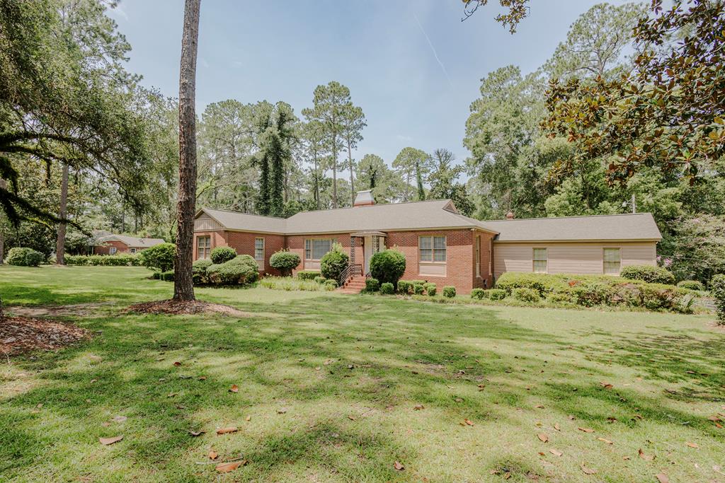 Charming, sprawling ranch-style home situated on more than 2.5 acres in a desirable Moultrie neighborhood named for the beautiful oak tree out front.  Built in 1949 and offering nearly 3,500 square feet, the home features three bedrooms, two-and-a-half baths, a sunroom, formal living and dining rooms, and a study or home office with a half bath. Hardwood floors and dentil crown molding add character throughout, while a graceful arched opening connects the living and dining rooms. The kitchen's fun checkered laminate flooring adds a cheerful retro touch.  The home has many of its original features and is ready for a new owner to make it their own. With mature plantings, plenty of indoor and outdoor space, and lots of charm, this property has so much to offer!                                                                                                       **Estate sale in progress. Home is available for showings while estate sale is underway (approximately 6 weeks). Personal property will be removed prior to closing unless otherwise negotiated.