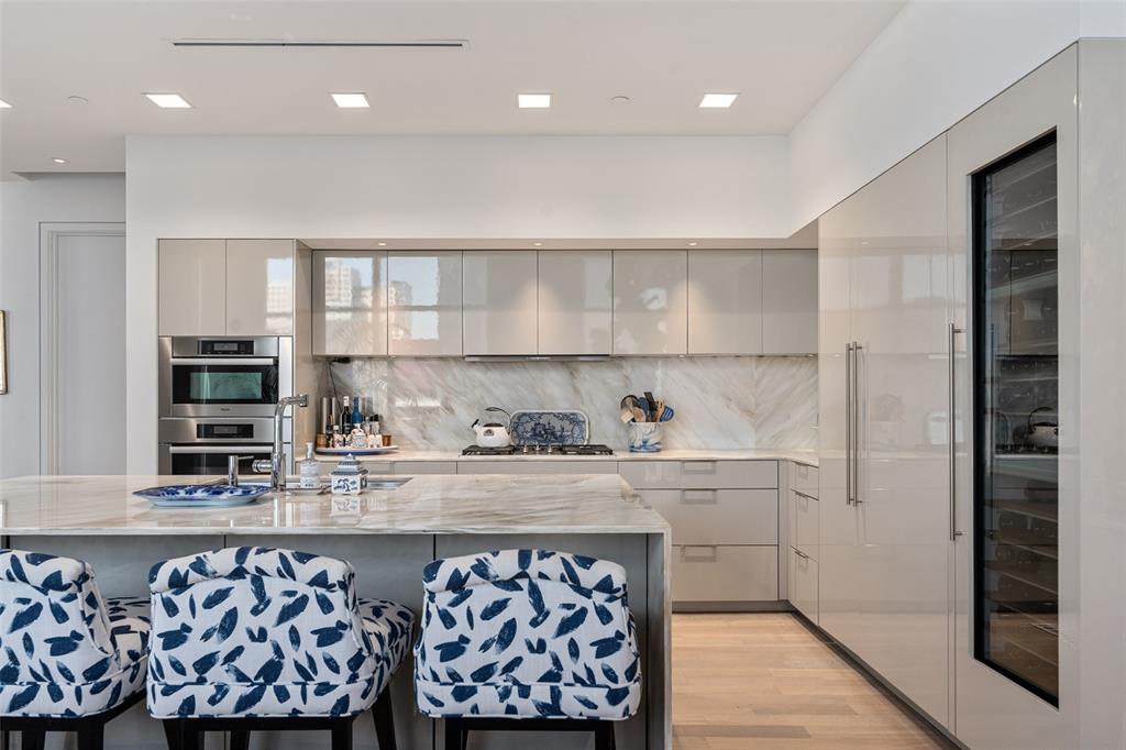 Positioned on the fifth floor in Museum Tower, a purely residential oasis, one enjoys a tree-top vantage point, offering a unique perspective of Dallas with lush greenery and city views that create a more intimate feel than the typical high-rise experience. Direct elevator access opens to a private entry with expansive living and dining spaces defined by gallery-style walls, and abundant natural light. Spanning approximately 4,095 square feet this two-bedroom, two-and-a-half-bath home has been thoughtfully designed.  The kitchen is anchored by custom lacquer cabinetry, Miele appliances, including a gas cooktop and wine tower. The main living area has a wet bar with a Scotsman ice maker, Phillip Jeffries wall coverings and dining room.  The primary suite features access to a private terrace, custom Poliform closet and a spa-inspired bath. The Sky Room, offers sweeping views is suited as a second living area, study, or private lounge. Museum Tower is in the heart of Y’all street, attracting global financial institutions to Texas; a tax friendly state. Steps from the Dallas Arts District and Klyde Warren Park. Amenities include 24-hour concierge and valet services, an 80-foot pool, great lawn, fitness center, saunas, guest suites, and dog park. World-class dining, shopping, and entertainment are moments away, offering a truly walkable and sophisticated urban lifestyle.
