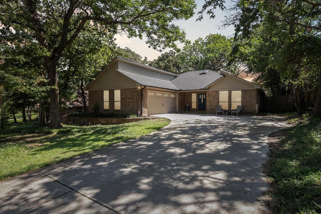 Paradise in Trophy Club! DFW's original planned development. Wooded lot, cul-de-sac cove, beautifully maintained. Open spaces, natural light, quality wood laminate flooring. Northwest ISD. Parks, walking trails, golf course community. Between Dallas & Ft Worth. 14 minutes to DFW AIRPORT. 3 bedrooms, fireplace, backyard patio for outdoor living. Oversized owner's suite with backyard access for privacy. Jack & Jill style bathroom connects both bedrooms. Front bedroom can easily double as a home office. Cathedral style wooded ceiling, fresh paint. Oversized 2-car garage.  The home is situated on a large lot, with a deck and mature trees out back. Ideally located just around the corner from Hutchins BBQ, HG Supply Co, Trophy Club Country Club nearby, Harmony Park with pickleball courts, ball fields, playground, and more! Come see why people love the Town of Trophy Club!