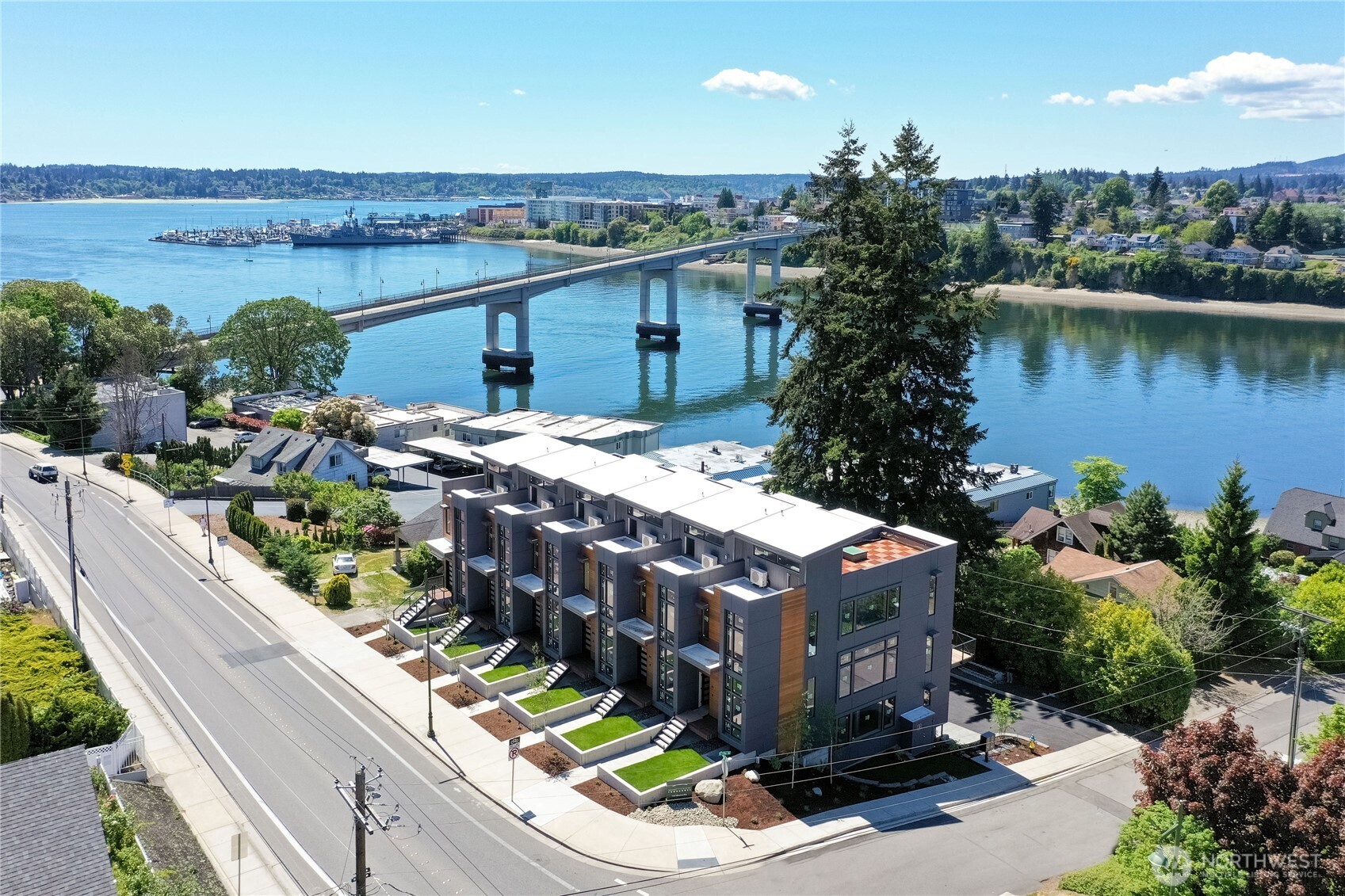 Experience luxury living in Manette Townhomes—a charming waterside community just blocks from dining, entertainment & the Bremerton-Seattle Fast Ferry. This stunning corner unit with only one shared wall showcases Olympic Mountain & water views from large windows. Watch whales & boats glide by from two decks, including a spacious rooftop. Features include soaring ceilings, quartz counters, elegant lighting, a stylish electric fireplace & efficient HVAC. Primary suite offers a walk-in closet & dream shower. Low-maintenance, peaceful lifestyle with a smooth commute to downtown Seattle.