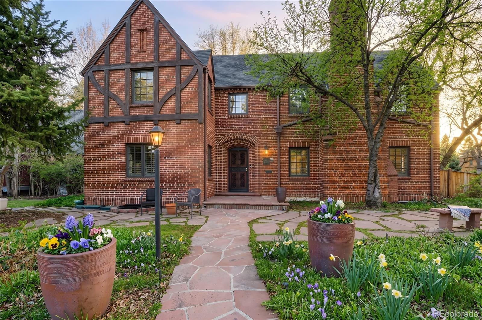 Open House Wednesday (4/8) 4-6pm & Saturday (4/11) noon-2pm. Situated along the tree-lined 17th Avenue Parkway, this 1936 Tudor blends historic charm with modern comfort. Step inside to sun-drenched living spaces where laughter and conversation flow effortlessly. The kitchen, with ample counter space (2 islands), opens to a spacious family room and backyard oasis—perfect for morning coffee, summer barbecues, or quiet evenings under the trees.Upstairs, each bedroom offers a peaceful retreat, with the primary suite featuring a steam shower and generous closets. The finished lower level has another beautiful living space with brand-new window wells, storage with a safe as an entrance, and a guest bedroom—truly a home that has it all. An electric car charger in the attached 2-car garage is a bonus, keeping life convenient.Ideally located in Park Hill, this home balances timeless character with everyday living and the vibrant energy of Denver just steps away.