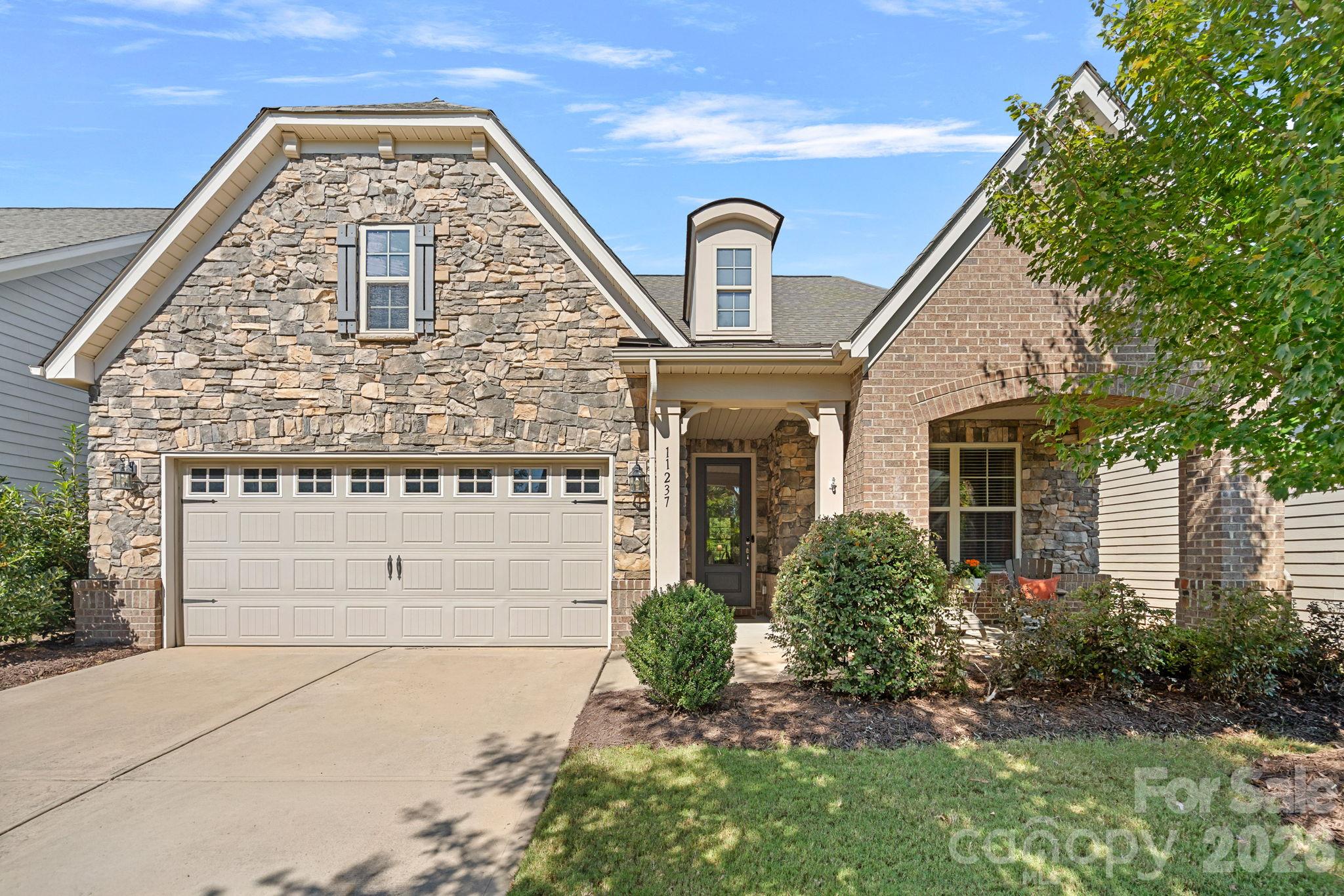 Welcome to Chapel Cove, where thoughtfully designed living meets the natural beauty of Lake Wylie! This inviting home offers comfortable living spaces and a versatile floor plan. The main-level owner’s suite provides a private retreat, while the beautifully appointed kitchen features an oversized island and spacious dining area. The kitchen opens to a welcoming family room with a gas fireplace, creating a warm and connected gathering space. A main-level guest bedroom offers flexibility for visitors or a home office. Upstairs, a spacious loft provides room to relax, work, or play, complimented by an additional bedroom and full bath. Enjoy outdoor living on the large covered back patio, ideal for morning coffee, dining, or unwinding at the end of the day. This home backs to a protected natural area, offering a peaceful setting with added privacy and a beautiful natural backdrop. Chapel Cove offers an exceptional outdoor lifestyle with access to Lake Wylie and an impressive array of resort-style amenities. Enjoy the outdoor pool, tennis, pickleball and basketball courts, playground, and scenic walking trails. Take advantage of the community’s lake access to launch a canoe or kayak and spend sunny days on the water or savor sunsets over the lake. With its flexible living spaces, tranquil natural setting, and outstanding community amenities, this home offers the best of lakeside living.