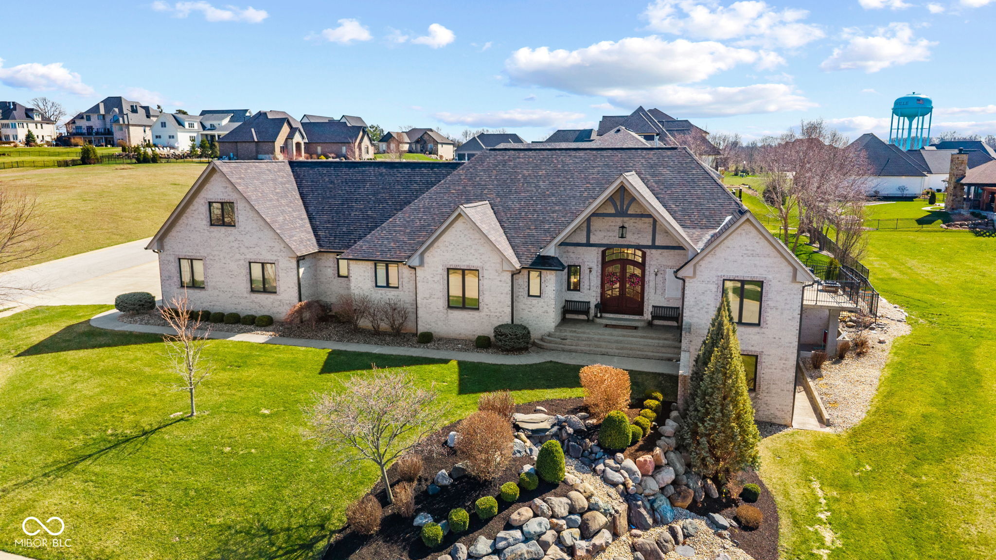 Experience refined living in this extensively updated custom estate offering over 6,000 square feet of elevated design, thoughtful functionality, and timeless finishes-all located within the highly sought-after Center Grove school district. A true standout, this home has undergone significant upgrades inside and out, providing both luxury and peace of mind. Recent exterior enhancements include a new roof, gutters, garage doors, and fencing (2023), along with a beautifully resurfaced pool, new pool cover, and patio pavers (2024), creating a private outdoor retreat with a fully fenced backyard designed for entertaining. Inside, the heart of the home is a completely reimagined chef's kitchen featuring quartz countertops, custom KraftMaid cabinetry with soft-close features and pull-outs, a 48-inch refrigerator, double convection ovens, gas cooktop, apron sink, and pot filler. The adjacent living spaces are warm and inviting, anchored by one of two indoor fireplaces and complemented by refinished hickory hardwood floors (2023) and all updated lighting throughout. The primary suite offers a true retreat with a fully remodeled spa-inspired bathroom (2022). The finished lower level expands your living experience with a basement bar, home gym, and additional entertaining areas-perfect for hosting at any scale. Seamlessly blending indoor and outdoor living, the home features three fireplaces total, including two indoors and one outdoor focal point ideal for year-round enjoyment. Smart home features include WiFi-enabled thermostats, interior and exterior cameras (included), and a surround sound system with Bluetooth/WiFi connectivity. Additional highlights include dual HVAC systems, three washer and dryer hookups, a side-load garage, and generous living spaces designed for both everyday comfort and elevated entertaining. An exceptional opportunity to own a move-in ready home where luxury meets lifestyle-without compromise.