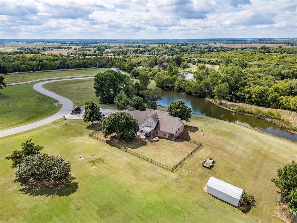 Experience the best of both worlds — peaceful country living right in the city. This beautiful home sits on over 6.5 acres of picturesque land complete with mature trees, open pastures, and your very own private stocked pond. Whether you’re sipping coffee on the covered patio, watching wildlife by the water, or enjoying sunsets that paint the sky, this property offers a rare blend of tranquility and convenience. Inside, you’ll find spacious, light-filled rooms that invite you to slow down and stay awhile. The large living area features expansive windows overlooking the property and a cozy brick fireplace that anchors the space with warmth and charm. The open dining and kitchen area makes entertaining easy, while the primary suite provides a serene retreat with access to the patio and views of the land. Outside, there’s plenty of room for hobbies, gatherings, or even future projects — including a storage building, fenced yard, and circular drive for easy access. Zoned rural, up to two horses are allowed. New aerobic septic system & RainSoft water softener installed in 2020. Located within city limits, this home offers the privacy of rural living with quick access to shopping, and major highways. If you’ve been searching for a property that combines nature, space, and convenience — this is it.