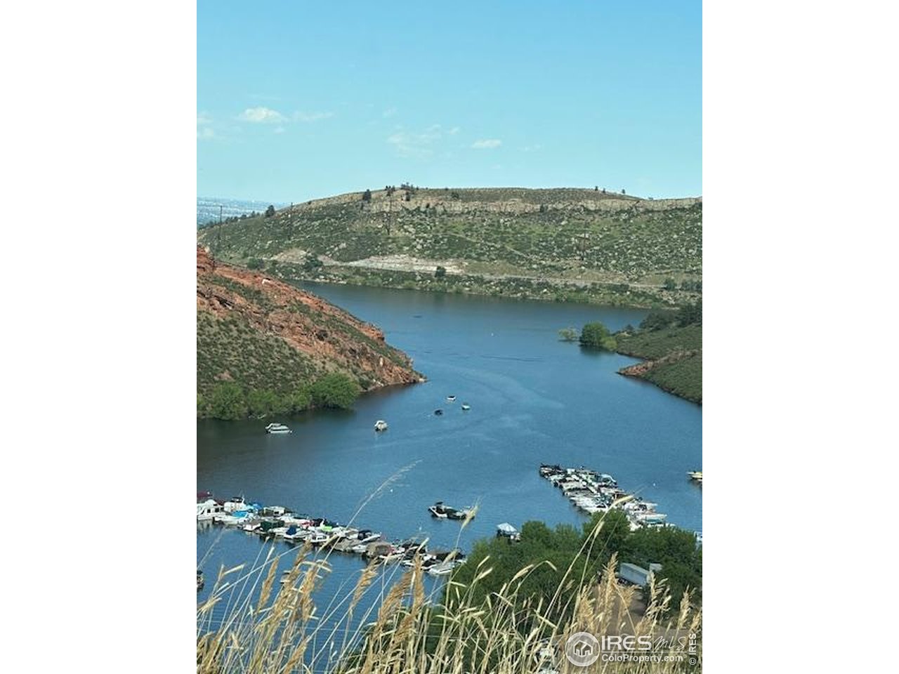 The VIEWS! Imagine waking up to breathtaking panoramic vistas of sparkling Horsetooth Reservoir right from your future dream home! This exceptional, one-of-a-kind vacant lot stands out as one of the few remaining fully build-ready parcels in this coveted area-saving you time, hassle, and significant expense. All major infrastructure and approvals are already in place, making it truly turnkey for your custom build: Sewer line extension completed, Sewer tap paid for, Electric meter installed and power brought to the property. Approved well permit secured, approved setback variance obtained, site excavation performed, and more. Custom architectural drawings tailored specifically to this lot's topography and stunning orientation are available to convey with the purchase-jumpstart your vision without starting from scratch! Over $130,000 in improvements have already been invested positioning this lot at an incredible value in a market where prime reservoir-view properties are scarce. Enjoy unparalleled access to world-class outdoor recreation: boating, sailing, fishing, hiking, mountain biking, and more just moments away, with the reservoir's iconic red rock formations and foothills backdrop as your everyday scenery. Don't miss this rare opportunity to claim one of the last ready-to-build lots with unbeatable Horsetooth Reservoir views-priced to sell and ready for your dream home today!