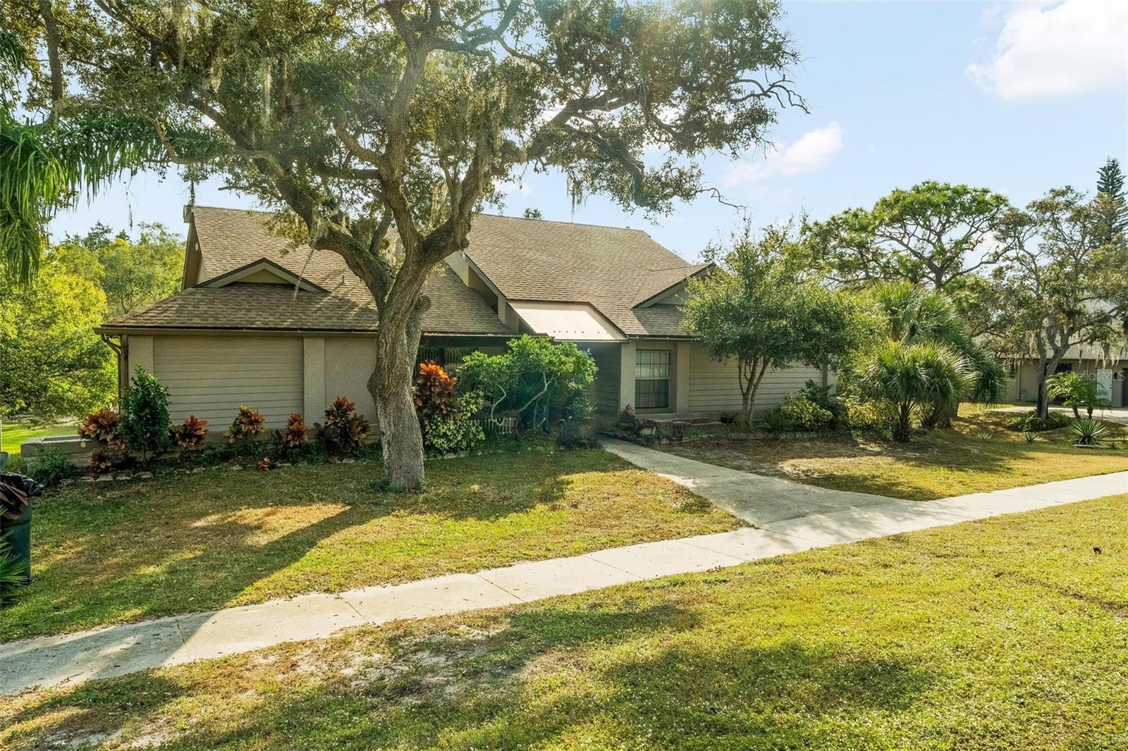 Just minutes from the award-winning Caladesi and Honeymoon Island State Parks, this former Ruttenberg model home for the WaybridgeSubdivision offers a combination of space, privacy, and coastal living. With slightly over 3,600 sq ft of living space, this thoughtfully designed 4-bedroom, 3 full bathroom split-floor plan, including a true walk-out basement, a unique feature in this area, makes it perfect for a growing family or multigenerational living. The main level features a spacious living room, a formal dining room, and a generously sized kitchen equipped with a center island cooktop, stainless steel built-in appliances, and an eat-in breakfast area. The primary bedroom plus the 2nd guest bedroom both have en-suite bathrooms. Sliding glass doors from the living room, primary bedroom, and kitchen open onto an extensive covered deck that overlooks the large private back yard and Curlew Creek, which flows directly into the Gulf, ideal for paddleboarding, kayaking, and enjoying serene water views. Downstairs, the large walk-out basement provides endless possibilities. Use it as an additional living space, convert it back into a 2-car garage, or design the bonus area to suit your lifestyle. Recent big-ticket updates include the roof (2025) and air conditioning (2022). For additional peace of mind, the home is equipped with a whole-home GENERAC generator ensuring uninterrupted comfort during unexpected power outages.