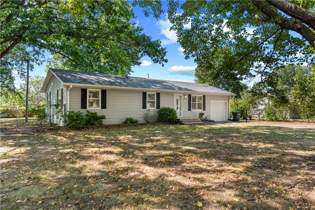 Located just outside the city limits of Nevada, Missouri, this 3-bedroom, 1-bath ranch-style home offers approximately 1,100 square feet of single-level living on a .35-acre lot. With a fenced yard, attached one-car garage, covered back patio, two storage buildings and a newer roof, this property offers a great combination of indoor and outdoor space.Inside, hardwood flooring runs through the living room and hallway, with carpet in the bedrooms. The home also features central heat and air, a functional kitchen and dining area, and a practical floor plan with plenty of opportunity to make the space your own.Outside, mature trees provide shade while the fenced yard offers room for pets, play, gardening or outdoor activities. The covered back patio creates a comfortable spot for relaxing, grilling or entertaining, and two storage buildings provide additional space for lawn equipment, tools, hobbies and seasonal items.The attached one-car garage adds convenient covered parking and additional storage. Located outside Nevada city limits while still offering convenient access to town, this property is a great option for buyers searching for a 3-bedroom home near Nevada, MO with a fenced yard, garage and extra storage.Schedule your private showing today!