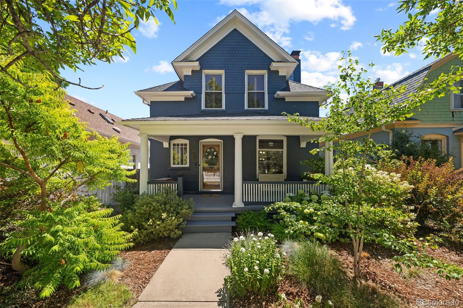 Welcome to this extraordinary Victorian home just a short walk from South Pearl Street and its incredible restaurants, cafes, farmers market, and vibrant neighborhood atmosphere. Framed by lush landscaping, the covered front porch and beautifully detailed exterior create an unforgettable first impression. Inside, hardwood floors, rich woodwork, intricate trim, stained glass windows, and a remarkable staircase showcase the artistry found throughout. The living room is filled with architectural beauty, featuring a decorative fireplace with an ornate wood surround, leaded glass accents, and a striking pressed tin ceiling. A spacious dining room provides an elegant setting for gatherings, while the nearby butler’s pantry offers beautiful cabinetry and a seamless connection to the kitchen. Designed to impress, the stunningly updated kitchen features deep blue cabinetry, quartz counters, stainless steel appliances, a large island with seating, and walls of windows that fill the space with natural light. The den provides flexibility for a home office, library, or quiet retreat. Upstairs, the bedrooms continue the home’s refined character with hardwood floors and detailed wood trim. The spacious primary suite feels like a private escape with multiple skylights, its own private balcony, a walk in closet, and plenty of room for a seating area. The beautifully updated five piece bathroom features dual sinks, a jetted tub, and a separate glass enclosed shower. The finished basement adds even more room with a large recreation area and built in storage. Out back, a private yard offers multiple spaces to enjoy the outdoors, including a pergola covered deck, patio, lawn, and mature landscaping. Located near Washington Park, trails, and light rail, this exceptional home offers historic beauty with easy access to everything Denver has to offer. Timeless craftsmanship and thoughtful modern updates come together in one of Denver’s most desirable locations. Come fall in love today!