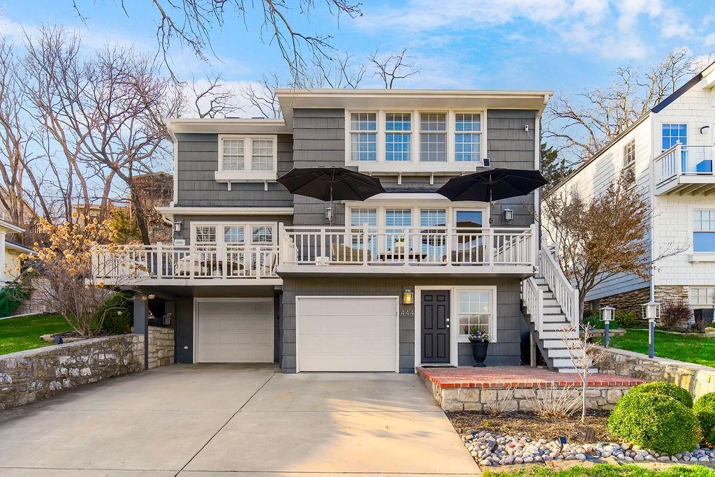 Imagine waking up to the serene beauty of Lake Quivira every morning in this meticulously updated home on Lakeshore Drive. Boasting a prime location with easy access to your private dock, this residence features a seamless open floor plan perfect for modern living. The spacious main level includes two bedrooms, while upstairs, a luxurious master suite awaits with breathtaking panoramic lake views from its own private deck. Hardwood floors gleam throughout, complementing the stunning island kitchen with a massive centerpiece island—perfect for gathering and entertaining. Every inch of this home is decorated meticulously, offering a stylish and inviting atmosphere that is completely move-in ready. Step outside to discover an incredible back patio complete with an outdoor fireplace, ideal for relaxing or hosting guests. The finished lower level offers versatility with a nonconforming fourth bedroom. Nestled within the gated community of Lake Quivira Country Club, residents enjoy access to exclusive amenities including a beach, clubhouse, workout facility, golf, and tennis courts, making this home a true retreat where every detail has been thoughtfully designed for modern comfort and luxury.