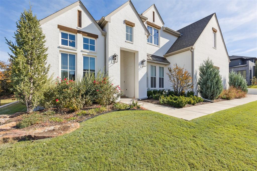 The stately contemporary white-painted brick exterior accented with rich wood lentil detailing sets the tone for this home’s striking curb appeal, gracefully positioned on its lot to create a grand presence. Step through the impressive iron front door into a space that radiates warmth and refined luxury, where soaring ceilings and hardwood floors establish an immediate sense of openness and elegance. The grand living room captivates with tall vaulted ceilings, a stunning masonry fireplace, and perfectly balanced built-in cabinetry anchoring the spacious entertainer’s living area, which flows seamlessly into the kitchen, dining room, and a wall of windows overlooking the backyard retreat. The gourmet kitchen is a true showpiece featuring quartz countertops, upgraded designer hardware, and custom cabinetry that extends into the dining area’s bar for effortless entertaining, while the walk-in pantry continues the elevated design with additional built-ins and matching quartz counters for beauty and practicality. The primary suite offers a serene escape with an oversized walk-in closet and convenient flow-through access to the spacious utility room, and the main level also includes a dedicated office with generous natural light and a guest suite featuring its own full bath adorned with designer Guild wallpaper. Upstairs, a large bonus room provides the perfect space for recreation or relaxation, while two spacious bedrooms—each with their own full bathrooms—offer comfort and privacy for family or guests. Outdoors, an expansive covered patio with a gas fireplace overlooks a private, tree-lined backyard creating a tranquil setting year-round. Nestled within a picturesque community offering a natural greenbelt, cabana and swimming pool, playground, and top-ranked Edmond schools. Notable upgrades include all-new upgraded carpeting on the staircase, in the primary suite, and in the primary closet.