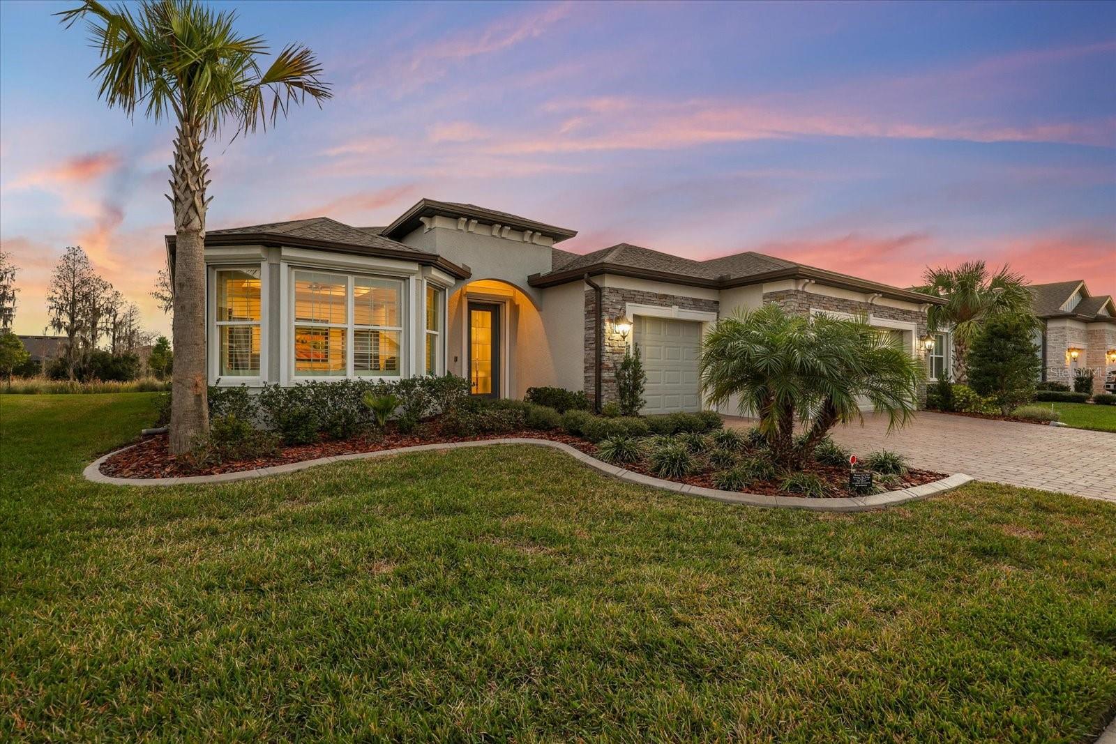 Live the Florida lifestyle in this exceptional Echelon Series home located in the highly sought-after gated Del Webb 55+ community in Land O’ Lakes. Designed for active adult living, this move-in-ready home offers luxury, connection, and resort-style amenities where neighbors become friends and every day brings the option to relax or stay socially engaged.Del Webb Land O’ Lakes features a 19,000+ sq. ft. clubhouse, resort-style pools, a state-of-the-art fitness center with classes, pickleball and tennis courts, a community garden, dog park, over 40 resident clubs and a full calendar of events coordinated by a dedicated Lifestyle Director—creating a true active adult lifestyle community.This beautifully upgraded home offers 2 bedrooms, 2.5 bathrooms, and a den with French doors, offering flexibility for a home office, third bedroom, or private retreat. The open-concept floor plan showcases coffered ceilings, 8-foot doors, custom millwork, crown molding, and designer finishes throughout.The entertainer-inspired kitchen features an oversized quartz island, upgraded appliances, soft-close cabinetry with pullouts, walk-in pantry, and a separate bar area with wine refrigerator—perfect for everyday living and effortless entertaining. The great room flows seamlessly to the outdoors through expansive pocketing sliding glass doors, creating ideal indoor-outdoor living.Step outside to the private lanai and enjoy true Florida living with a heated custom pool featuring a sun shelf, salt system, travertine pavers, cage lighting, and convenient retractable hurricane-ready screen. Overlooking an oversized conservation lot, this peaceful outdoor oasis is perfect for morning coffee, sunset cocktails, or quiet evenings.The luxurious primary suite includes plantation shutters, coffered ceilings, dual vanities, an oversized zero-entry walk-in shower, and a custom-designed walk-in closet, all complemented by serene conservation views that enhance the sense of retreat. Guests will appreciate the private ensuite bedroom featuring an expansive bathroom with walk-in shower and closet, also overlooking conservation views for added privacy and comfort. The massive laundry room is thoughtfully designed with custom built-in cabinetry on both sides, offering exceptional storage, workspace, and organization—making everyday tasks both efficient and elegant.Additional upgrades include a whole-home water softener, tankless water heater, gutters, landscape curbing, and the ease and convenience of installed roll-down hurricane shutters for peace of mind. The extended-depth three-car garage with custom epoxy flooring provides exceptional space for large vehicles, a golf cart, workshop space, or extra storage. HOA Fees include yard maintenance, plus internet and cable.Conveniently located near shopping, dining, golf, medical facilities, Tampa International Airport, and Florida’s beaches. Meticulously maintained and extensively upgraded, this move-in-ready Del Webb home reflects exceptional pride of ownership and thoughtful enhancements throughout, you only need to unpack and relax.Del Webb isn’t just a community—it’s a lifestyle. Your next chapter begins here.