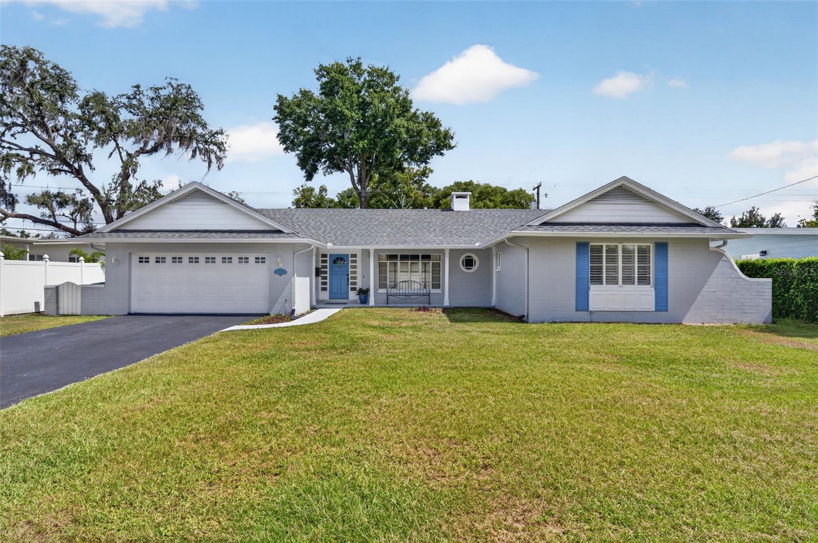 Located in sought-after Dommerich Estates, this single-story, 3-bedroom, 2-bathroom, block home offers 1,605 square feet of living space and an attached 2-car garage. A walkway leads to a covered front porch, where the character of the original construction is immediately apparent in the columns and detailed millwork surrounding the front door and sidelights. Inside, the main living spaces flow easily from one to another and include dining and living areas and a Florida room overlooking the backyard, with wood flooring, crown molding and a wood-burning fireplace adding warmth and character. Floor-to-ceiling windows fill the Florida room with natural light and open to a concrete patio for easy indoor-outdoor living. To the left of the entry, the kitchen and adjoining eat-in nook retain much of the home’s charm, with white wood cabinetry, a neutral tile backsplash, a window above the stainless double-bowl sink overlooking the backyard, stainless dishwasher, glass cooktop and built-in wall oven. Conveniently located just inside the garage entry, the kitchen makes unloading groceries easy, while the adjoining eat-in nook features decorative millwork, a large window and the continuation of the wood flooring. All three bedrooms are comfortably sized and feature custom interior shutters. The primary bedroom is positioned at the rear of the home with an en-suite bath featuring a glass-enclosed tiled shower and pedestal sink, while the two alternate bedrooms share a hall bath with a tiled tub/shower combination, newer vanity, undermount sink, granite countertop and linen closet. The .20-acre, 79’ by 111” lot offers room to enjoy the outdoors. Important improvements have already been completed, including a new architectural shingle roof in 2025, PEX repipe in 2011, interior electrical panel replacement and a 2017 HVAC system. Residents also have the option to join the Dommerich Beach Civic Association, with annual membership options currently beginning at $100. Membership provides access to the association’s private lake lot on the east shore of Lake Minnehaha, including a picnic area and canoe and kayak storage, with a separate membership option offering boat-ramp access. The location is compelling, with Dommerich Elementary and Maitland Middle within walking distance and zoning for Winter Park High. Minnehaha Park, also within walking distance, offers tennis courts, a playground and green space. Downtown Maitland, Lake Lily and its Sunday Farmers Market, the Art & History Museums of Maitland, restaurants, grocery stores and everyday shopping are all nearby, while Enzian Theater and additional recreation and conveniences are just a short drive away. With single-story block construction, an attached two-car garage, meaningful system improvements already completed and a location that puts schools, parks and the best of Maitland close at hand, this is a wonderful opportunity to put down roots in Dommerich Estates.
