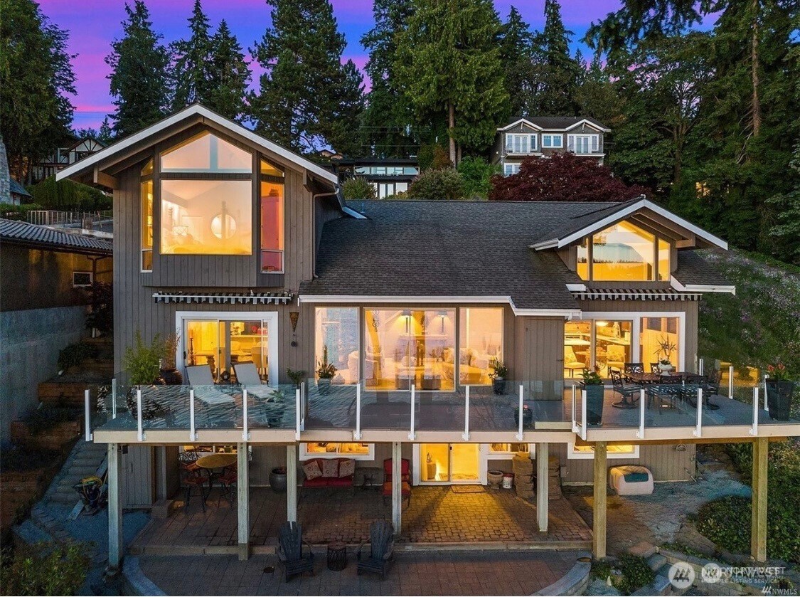 Experience spectacular sunsets and the ultimate in lakefront living on glimmering Lake WA. With over $100K in recent updates, this effortlessly sophisticated home is ready for you to fully enjoy life on the lake. Abundant daylight beams throughout. Lounge on the deck and marvel at the show on the water. Unwind on the terrace or stroll to your private dock. Sip a cold drink under the shady lakeside cabana w 3/4 bath & kitchen amenities. Or relax in the home where travertine floors flow through the open-concept floor plan. A full bar & a wine cellar. Seaplanes, Christmas boats, bald eagles, otters at play and deer. There’s even a secret room waiting to be discovered. Near Inglewood CC. A rare opportunity to own 68' of premium lake frontage.