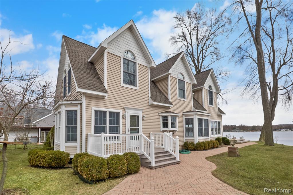 OFFER DEADLINE 3/30 AT 6:00PMExperience a truly rare opportunity on Portage Lake with 70 feet of pristine shoreline in front of thehome and an additional 70 feet of water frontage on a back lot with a 2nd garage. Home was completely re-built in 1999 and thoughtfully designed to maximize breathtaking lake views from every window,complemented by soaring ceilings on both levels and interesting architectural details throughout. Themain level features an expansive gathering space surrounded by windows viewing the lake. The spaciouskitchen is perfect for entertaining, with a large island, custom built-ins, and a charming breakfastnook. The mainfloor also has a private study/4th bedroom. Upstairs, the primary bedroom is a privateretreat with its own balcony, with stunning elevated views of the lake. 2 additional bedrooms upstairs,plus a sitting area that could be converted into a bedroom. This property encompasses 3 lots total, eachwith their own tax ID#. New roof 2025.