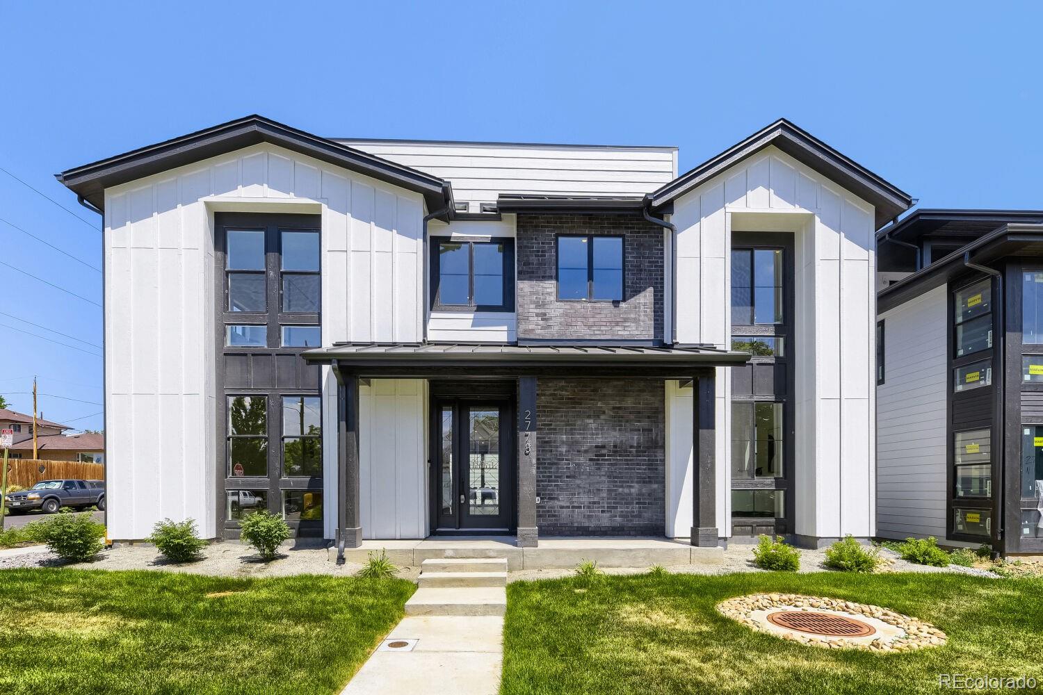 Brand New Luxury Home – Move-In Ready!  Corner homesite!  Experience exceptional living in this stunning modern farmhouse-inspired three-story home by BLVD Builders, located within an exclusive enclave of just 10 luxury homes in the heart of Sloan’s Lake. Thoughtfully designed with designer-selected finishes throughout, the home welcomes you with a charming covered front porch and a dramatic two-story foyer featuring a grand U-shaped staircase.  The main level offers a private office, guest bedroom with en-suite bath, and an impressive gourmet kitchen showcasing two-toned Masterpiece® cabinetry, premium Thermador® appliances, an oversized island, Brizo® fixtures, luxury Hinkley® lighting, quartz countertops, and a striking full-height quartz backsplash. The expansive great room is anchored by luxury tiled fireplace, creating a warm yet sophisticated gathering space.  Upstairs, the second level features three secondary bedrooms, a spacious laundry room, and a versatile teen room/flex space. The luxurious primary suite serves as a private retreat with a generous walk-in closet and spa-inspired bath complete with a freestanding soaking tub, oversized walk-in shower, dual vanities, and beautifully curated designer finishes.  Designed for entertaining, the third floor offers a media room, wet bar, powder bath, and an expansive rooftop deck with a built-in BBQ, providing the perfect setting for hosting guests and enjoying Colorado’s outdoor lifestyle.Distinctive exterior details include black-framed Low-E windows, refined architectural accents, an impressive 8-foot entry door, and professionally landscaped front and rear yards on a desirable 5,933-square-foot corner homesite. Residents enjoy walkable access to Sloan’s Lake Park, acclaimed restaurants, coffee shops, boutique shopping, fitness studios, and local breweries, all just minutes from downtown Denver.