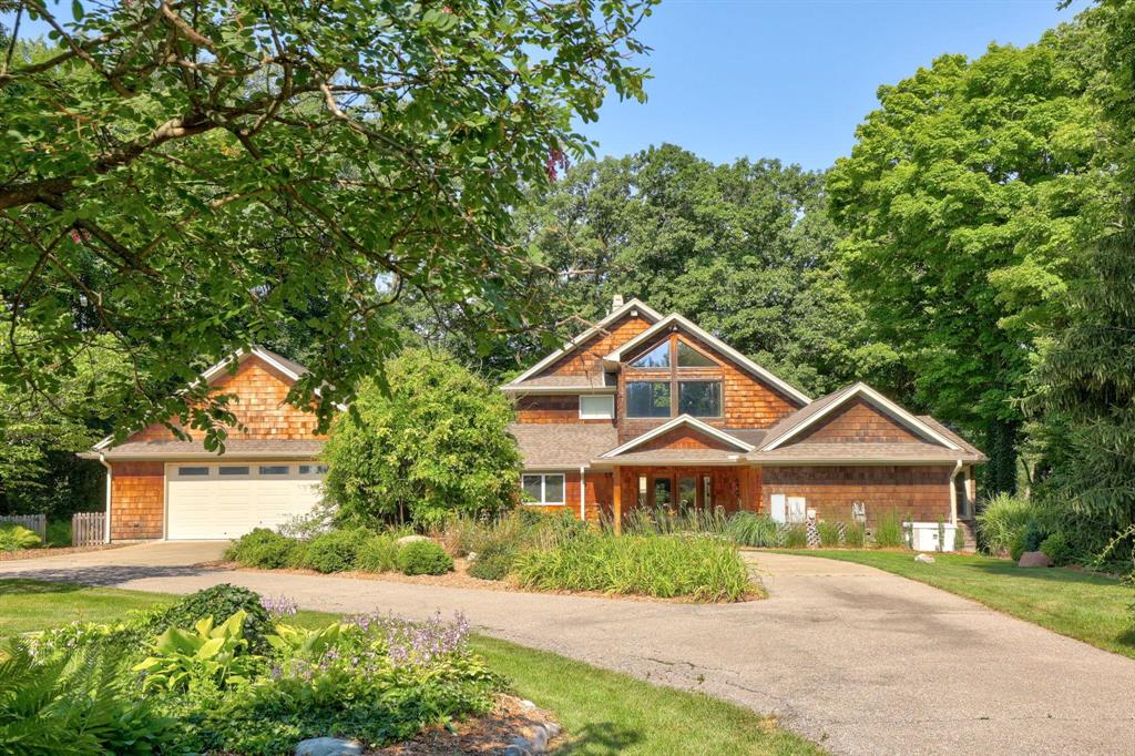 Perched high above the Cass River on six extraordinary acres, this one-of-a-kind Chalet-style residence offers 3,856 square feet of inspired living space where every room captures breathtaking views of the river and surrounding landscape. With easy river access, a historic inground pool, and a charming 1,100-square-foot guest cottage-ideal for visiting family or as a short-term rental-this property delivers the perfect blend of history, comfort, and opportunity. Rich in character and craftsmanship, the home features three bedrooms, two full and two half baths, and an inviting open-concept dining and living area designed for gatherings both large and small. The library, anchored by a striking fieldstone fireplace, creates a warm retreat, while the kitchen, complete with its own fireplace, serves as the true heart of the home-flowing seamlessly to a covered patio ideal for private outdoor entertaining. A sunroom connects the main living space to the attached garage, extending the home's livability and creating a natural transition to the outdoors. The first floor also includes two bedrooms with scenic river views-one offering an ensuite bath and private entrance, perfect for hosting guests or extended family. Upstairs, the primary suite is a tranquil haven with a spacious closet and dedicated office. The lower level exudes rustic charm, featuring a double-sided fireplace, a bar area, a flexible studio space for art or music, a half bath, and direct access to the hot tub. This remarkable property minutes from Frankenmuth celebrates the best of Pure Michigan living-with riverfront access for fishing, kayaking, and gardening, all within a setting that radiates peace, beauty, and timeless appeal.