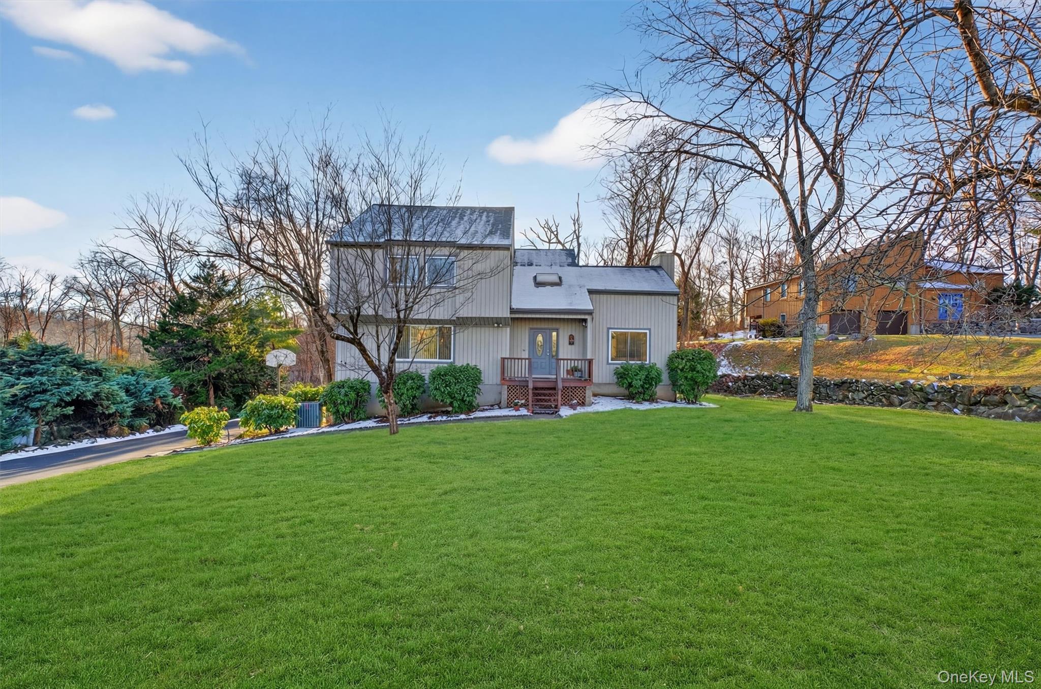 Welcome to 33 Maple Moor Lane - a beautifully updated, light-filled contemporary home  on a quiet sought-after cul-de-sac in Cortlandt Manor.Thoughtfully expanded and meticulously redesigned this move-in-ready residence offers a bright, open floor plan with clean modern lines and sun-drenched living spaces ideal for both everyday living and effortless entertaining.  The expansive living room features soaring ceilings and double sliding doors, flowing seamlessly into a formal dining room, wet bar and updated kitchen and great room anchored by a charming bay window.Upstairs the primary suite serves as a true retreat, complete with a spa-like bath featuring a corner jacuzzi, custom shower and three walk-in closets, including a cedar closet.  Three additional bedrooms and a study provide the fleixibility today's buyers expect.Refined finishes throughout include hardwood floors, updated bathrooms, and a fresh, neutral palette.  A private deck just off the main living space in a secluded half-acre setting with mature trees in a scenic conservation area behind the deck and rear yard. This is ian deal for outdoor dining and peaceful recreation.  The lower level adds approximately 540 square feet of versatile bonus space - ideal for a home gym, studio or recreation area - along with a large enclosed shed for additional storage.  Recent improvements, including a new roof with warranty and a new A/C system offer added value and peace of mind.Set in a low-traffic neighborhood with a strong sense of community, this home provides convenient access to parks, shools, shopping and two Metro-North RR stations - an excellent option for commuters seeking both comfort and convenience.  Well maintained, fully updated homes in prime cul-de-sac locations are limited.  Schedule your private showing and see firsthand what makes this home stand out
