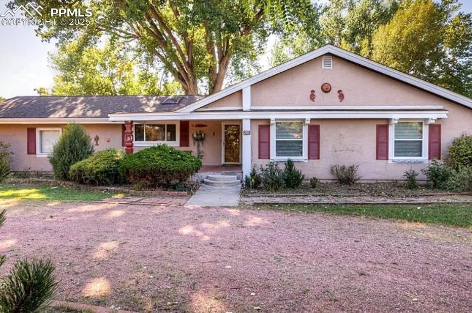Discover this beautifully maintained 4-bedroom, 3-bath ranch home perfectly positioned on a rare 0.66-acre lot backing directly to the Valley Hi Golf Course, offering exceptional privacy and unobstructed views of Pikes Peak and the Front Range. This spacious 3,518 sq ft property features an open and functional floor plan with 1,759 sq ft on the main level and a fully finished lower level ideal for multi-generational living, entertaining, or a dedicated media space. The main level includes a large living room with a cozy fireplace, a roomy kitchen with abundant counter space, a formal dining area, and two well-sized bedrooms, including the primary suite with a jetted soaking tub. The basement adds two additional oversized bedrooms, a full bathroom, a large family room, laundry area, and plenty of storage. Car lovers and hobbyists will appreciate the attached 4-car garage, offering exceptional room for vehicles, tools, or workshop space. The huge backyard opens to sweeping golf course views, making it perfect for relaxing, hosting, or enjoying spectacular Colorado sunsets. With central air, natural gas heat, stucco exterior, and a quiet, established neighborhood close to hospitals, parks, schools, shopping, public transit, and walking trails, this Valley Hi property offers the ideal blend of convenience, comfort, and outdoor beauty—all with no HOA. This is a rare opportunity to own a large ranch home on an oversized lot in one of Colorado Springs’ most desirable golf-course communities.