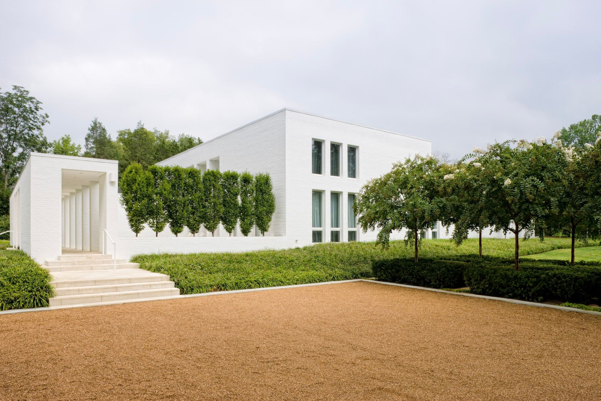 Perfectly placed among the timeless estates of Belle Meade is one of Nashville’s most architecturally significant private residences, a home that is as enduring as it is extraordinary.Occupying a rare, level 1.38-acre site just footsteps from Percy Warner Park and Belle Meade Country Club, this remarkable custom residence was envisioned by its original owner and brought to life by an unrivaled team of design talent. The striking architecture by Larry Woodson, Woodson Gilchrist Architects, landscape architecture by Mike Kaiser, of Kaiser Trabue Landscape Architects, and interiors by Katy Chudacoff, Dovetail Design, come together in perfect harmony to create a home that feels as relevant today as it was at completion. The crisp white architecture is quietly dramatic, defined by clean geometry, soaring volumes, walls of glass, and an effortless relationship between interior and exterior spaces. Every room was designed to celebrate natural light, frame garden views, and create an atmosphere of understated luxury.At the heart of the home, expansive living spaces flow seamlessly to a private courtyard where the resort-inspired pool, limestone terraces, and meticulously curated gardens become an extension of the home’s architecture. Whether hosting elegant gatherings or enjoying quiet mornings, the connection between indoors and outdoors is exceptional.Inside, interior finishes were selected with restraint and intention. Gallery-like walls showcase art beautifully, while warm natural materials soften the contemporary architecture, creating spaces that are both sophisticated and remarkably comfortable. Properties of this architectural caliber are seldom offered in Belle Meade. More than simply a residence, 734 Jackson Boulevard represents a rare opportunity to own one of Nashville’s iconic contemporary landmarks. A home whose design, craftsmanship, and setting will remain timeless for generations to come.Please note videos and floor plans are attached
