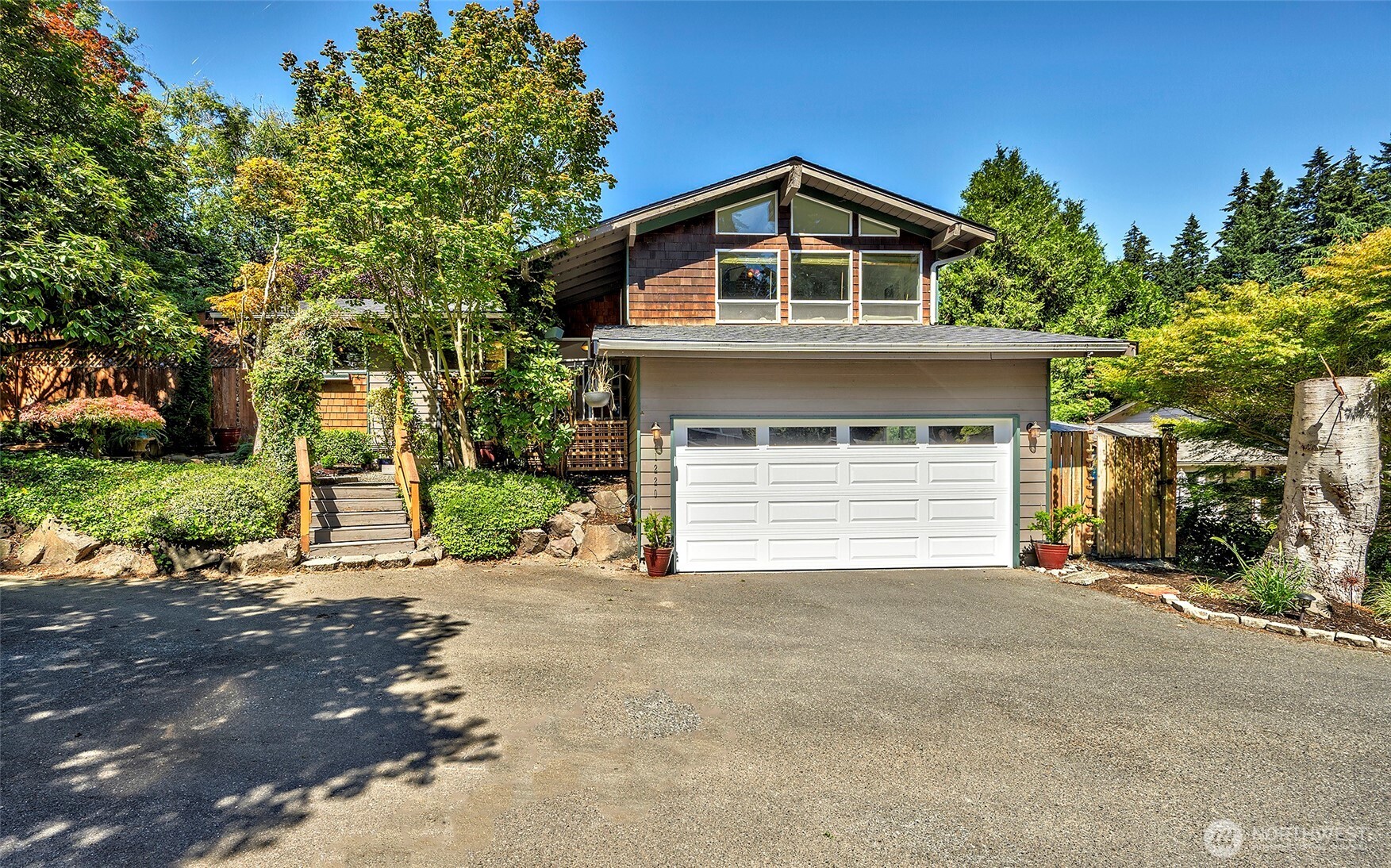 This updated 4 bedroom house is located in one of Edmonds' exceptionally desirable neighborhoods. The Yost Park community offers a quiet, natural setting with forested trails, a public pool and local parks. In this wonderfully wooded area, the house is situated right next to a peaceful greenbelt on a dead-end street in a small cul-de-sac. Updates include: new roof, LVP flooring in upper level, carpet in lower level, refinished shower walls in two bathrooms, light fixtures, bathroom vanity and utility sinks, some interior paint and kitchen appliances, garage door and opener. With nearly 2,500 square feet of living space, it has several double features: two private decks, 2 master bedrooms, fireplaces, sheds/outdoor storage areas, 2 car garage, double french doors, plus walking distance into two parks. The upper level features an open floor plan with vaulted ceilings, a lovely living room with a fireplace and large kitchen that features custom French doors leading into a private deck perfect for entertaining. The main level has three bedrooms, two bathrooms and leads out into another private deck area. The lower level offers another master bedroom with a walk-in closet, full bathroom with storage space, large rec room, office/den with a fireplace and a sliding glass door into the backyard, utility room, plus several storage closets. The backyard is fully fenced with a side dog-run. Welcome to Yost Park with high walkability to restaurants, the beach, parks ane more.
