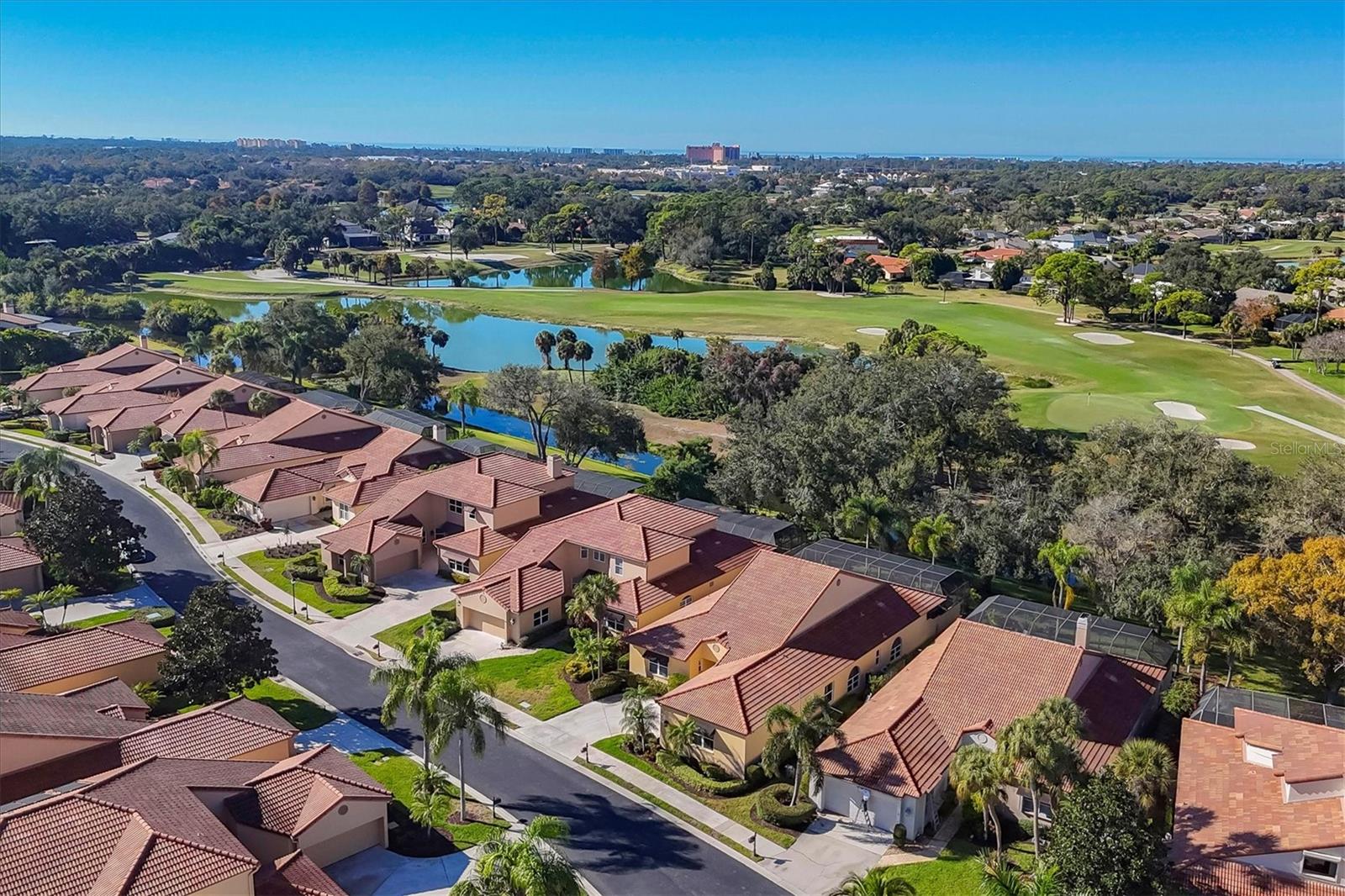 Located in the picture-perfect private gated community of TPC Prestancia,  this one level free standing home is the perfect indoor-outdoor living arrangement with awesome views of water and the golf course.  Beautifully maintained, the home features travertine flooring in most rooms, vaulted and trey ceilings, recessed lighting  and plantation shutters on most windows. From the moment you enter, every where you look portrays an inviting welcome. The main living area has two French doors that extend the living area to the expansive screened-in outdoors with an  in-ground pool with spa, wet bar and two separate sitting areas; one with a fire pit and one under cover. The kitchen is open to the living room and the family room. The bedrooms are a split plan with the primary bedroom viewing the pool and outdoor areas and separate his and her bathrooms. Two car attached side entry garage. Residents of Prestancia enjoy 24-hour guard-gated security, beautifully manicured grounds, and the option to join the prestigious TPC Prestancia Golf Club, home to two championship 18-hole courses and a vibrant social community.  The community provides landscape maintenance, exterior upkeep including roof repairs, pest control and dwelling insurance.