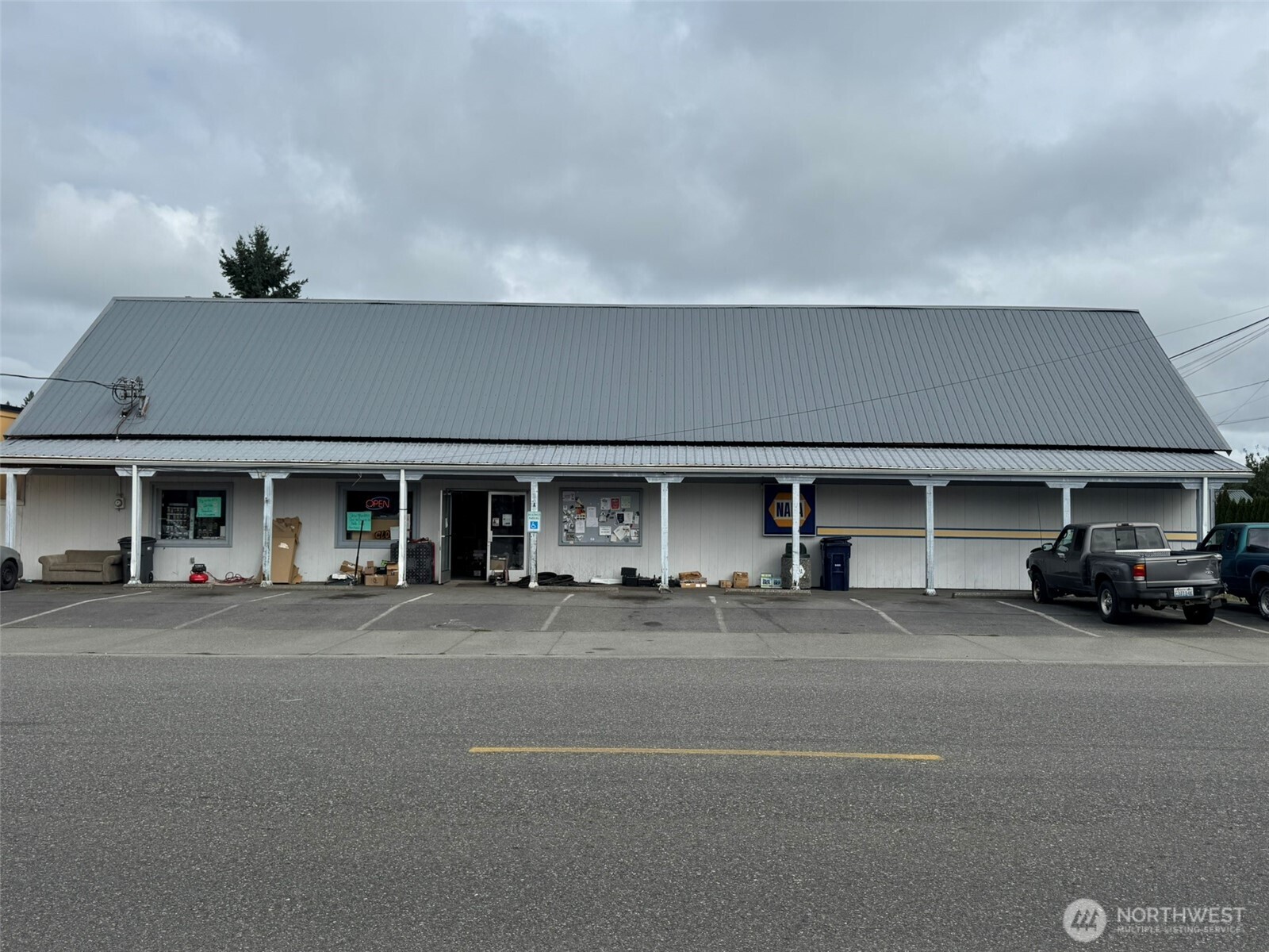 UNIQUE INVESTMENT OPPORTUNITY!  Total of 5,696sf of space on main street! Approx 3900sf of commercial space, currently on month-to-month lease to NAPA Auto Parts who've occupied it for decades. Auto repair shop conveniently located next door.  Additional approx 1800sqft, 4 bed/2 bath residential space at back of building w/separate entrance located at 705 Emens Ave. Live & operate your business in the same bldg, rent out both spaces, or occupy 1 & rent the other. So many possibilities, including the option to continue the current lease to NAPA owner/operator! Upgrades have been completed on the apt: interior paint, vinyl plank flooring, & fresh entry porch exterior paint. Buyer verifies all. Also offered as residential Listing 2431035.