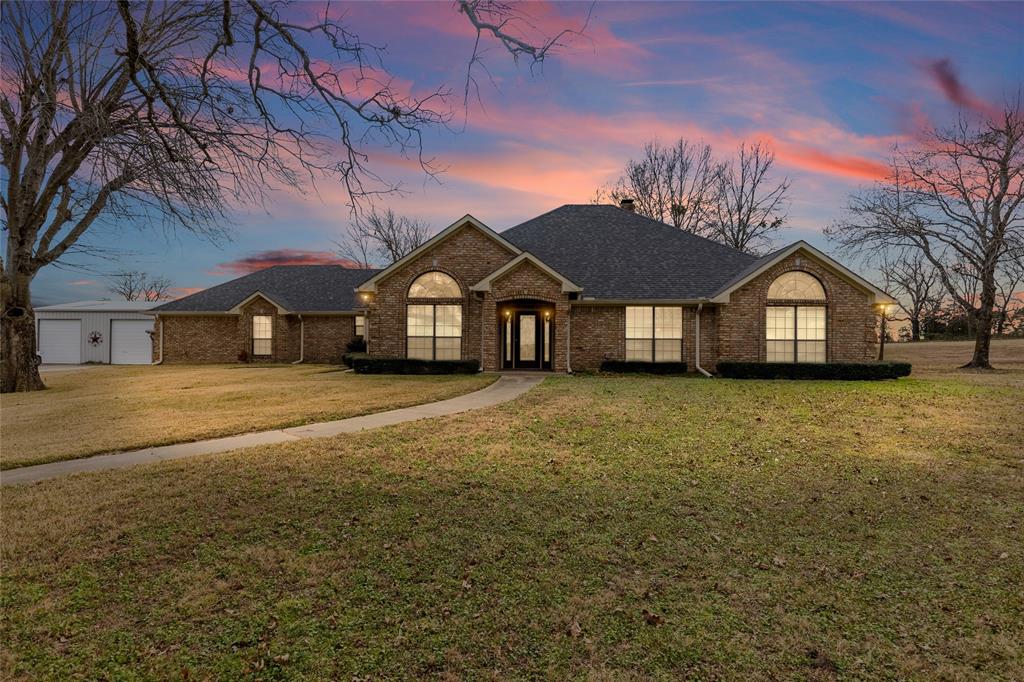 This gorgeous 68-acre estate offers the perfect blend of luxury and utility, featuring a move-in ready 2,857-square-foot brick home with an apartment in workshop! Enjoy the brick wood-burning fireplace in the living room that also comes with a wet bar, sink, and mini-cooler. Luxurious wood floors flow throughout the foyer and halls. A vaulted formal dining room and separate breakfast room give you space for entertaining. The crisp-white gourmet kitchen is a chef’s dream with granite countertops, double oven, a mini cooler, breakfast bar, and a walk-in pantry. Retreat to a primary suite featuring its own private fireplace and a double-sink vanity. Bring your outdoor furniture and take advantage of the views from a large covered back patio! A picturesque pond, and a front yard filled with mature trees, provides an idyllic place to call home. High-speed internet keeps you connected while living in a quiet countryside setting near lakes. For guests, you'll find a workshop with an apartment that includes a kitchen, living room, and bedroom with bathroom. For those big gatherings, the workshop has an additional full kitchen and large bay area, adding versatility for parties, a hobby area, workshop, or flex space. Minutes away are Lake Cypress Springs, Lake Bob Sandlin, and Lake Winnsboro. With high-speed internet and extensive road frontage on 3 sides, this expansive property serves as the ultimate modern sanctuary.
