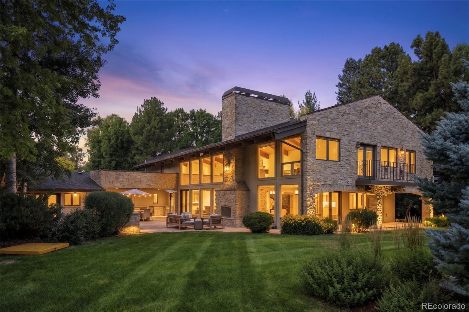 Nestled within an exclusive enclave of prestigious Old Cherry Hills, 4980 S. Lafayette Lane is a remarkable custom limestone estate set on an exceptionally private 1.13-acre homesite surrounded by towering mature trees & lush, park-like grounds. A gated entrance, circular drive, elegant stone pillars, wrought-iron fencing, copper gutters, and custom metal architectural accents create an unforgettable arrival, while the tandem five-car garage includes a separate bay ideal for recreational vehicles,home gym,flex space for a workshop, or hobby room.Designed to embrace Colorado's coveted indoor-outdoor lifestyle, the spectacular grounds offer the perfect balance of recreation and tranquility. A regulation-style sport court with dual basketball hoops compliments a serene water feature and a secluded garden retreat surrounded by mature landscaping. The expansive flagstone patio and covered stone terrace create exceptional outdoor living spaces, featuring a built-in barbecue, an impressive stone fireplace with hearth, ideal for entertaining. Inside, the thoughtfully updated residence offers expansive living spaces filled with natural light. Dramatic two-story vaulted ceilings, floor-to-ceiling windows, and natural hardwood flooring create a warm yet sophisticated atmosphere throughout. The beautifully renovated chef's kitchen is appointed with professional-grade appliances, substantial quartz countertops, a large center island with breakfast bar, and a spacious casual dining area overlooking the backyard. A large walk-in pantry featuring a full-size built-in refrigerator, speed oven, microwave, and storage. Multiple decks, 6 incredibly large bedrooms, huge mudroom, impressive skylights and comfortable lower level with full gym.Combining timeless architecture, exceptional craftsmanship, luxurious amenities, and one of Old Cherry Hills' most private settings, this extraordinary estate offers an unparalleled lifestyle in one of Denver's most sought-after neighborhoods.